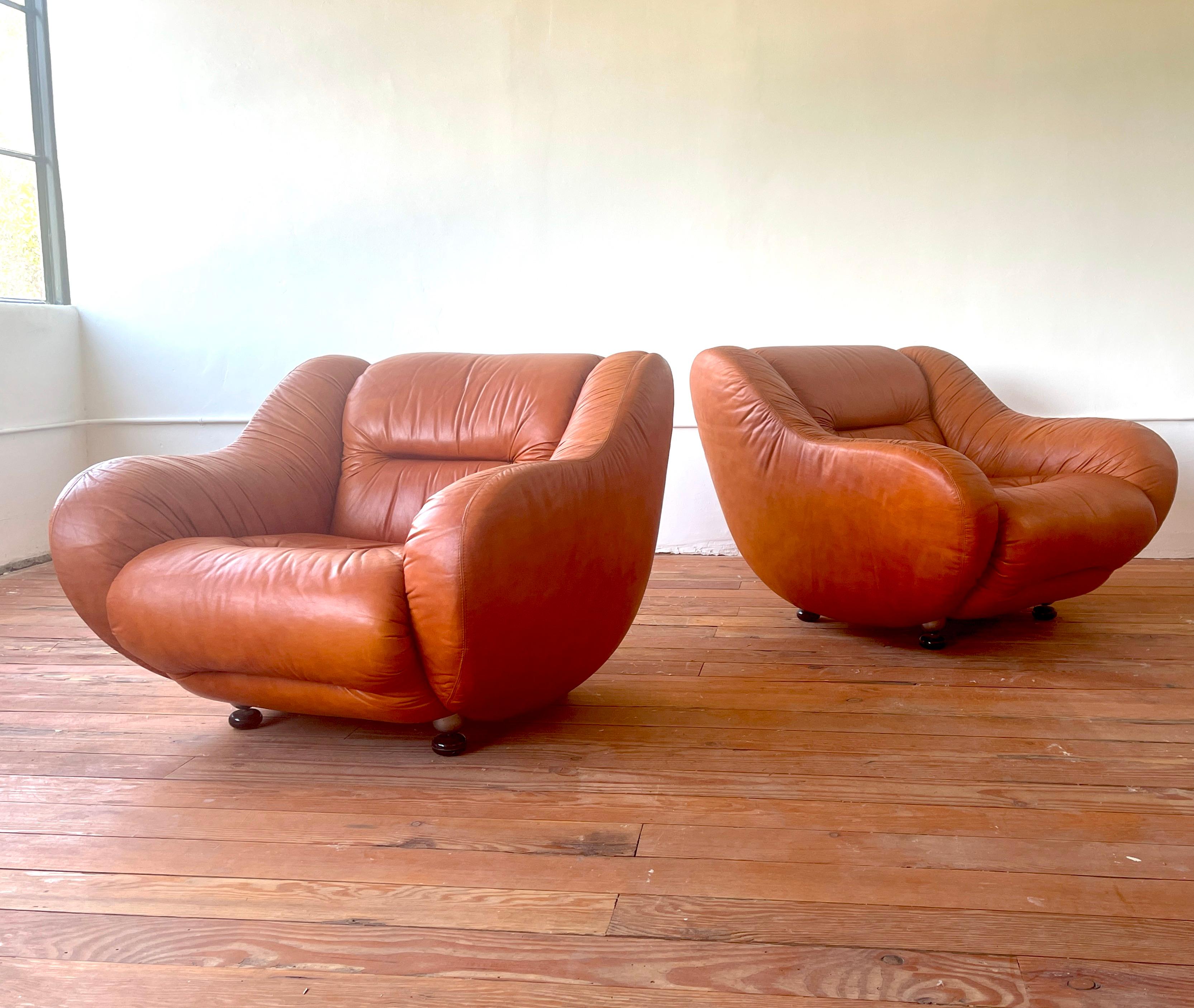 Incredible pair of Italian leather club chairs, Italy - 1950's
Soft carmel leather with sloped arms with floating wood ball shaped feet
Great sculptural form