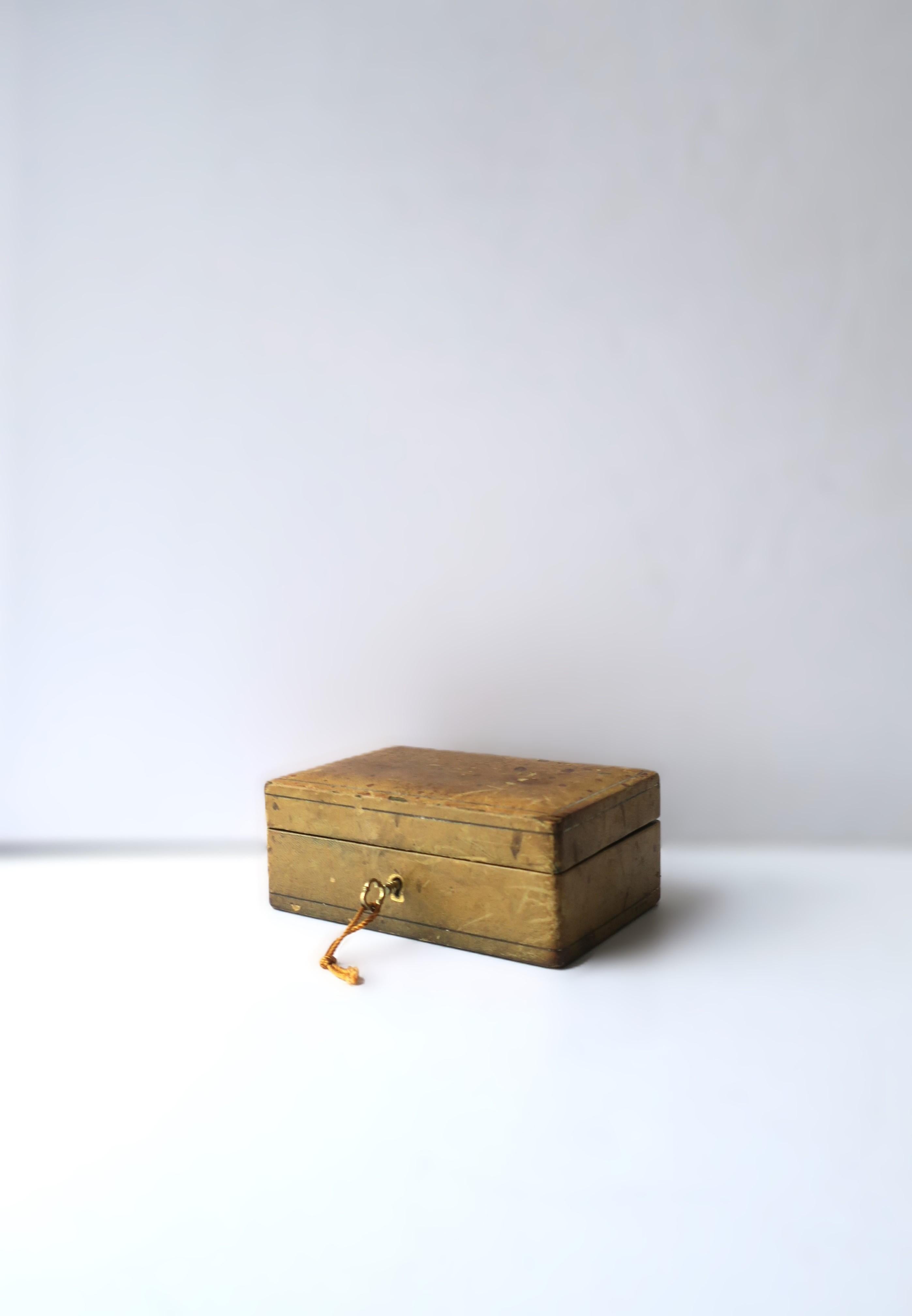 An Italian leather jewelry box, circa mid-20th century, Italy. Box has an endearing weathered leather exterior, velvet interior, with lock and brass key on small silk cord. Piece is marked on underside, lower right-side corner, faded (please see