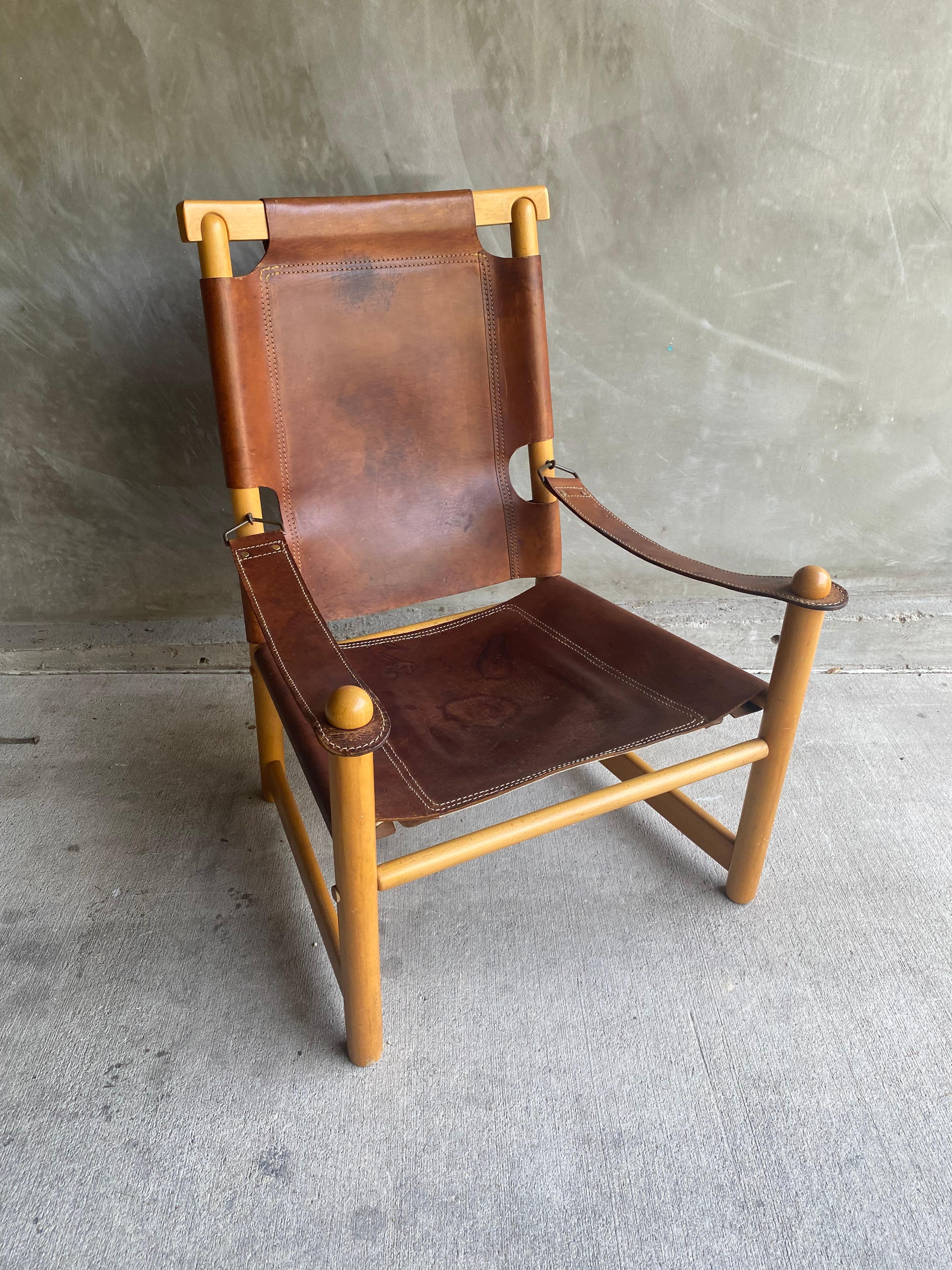 Handsome cognac and beech sling chair with unique details at arms and back.  Comfortable as is or with the addition of a seat cushion.  Style of Bernini, Italy, 1960's.