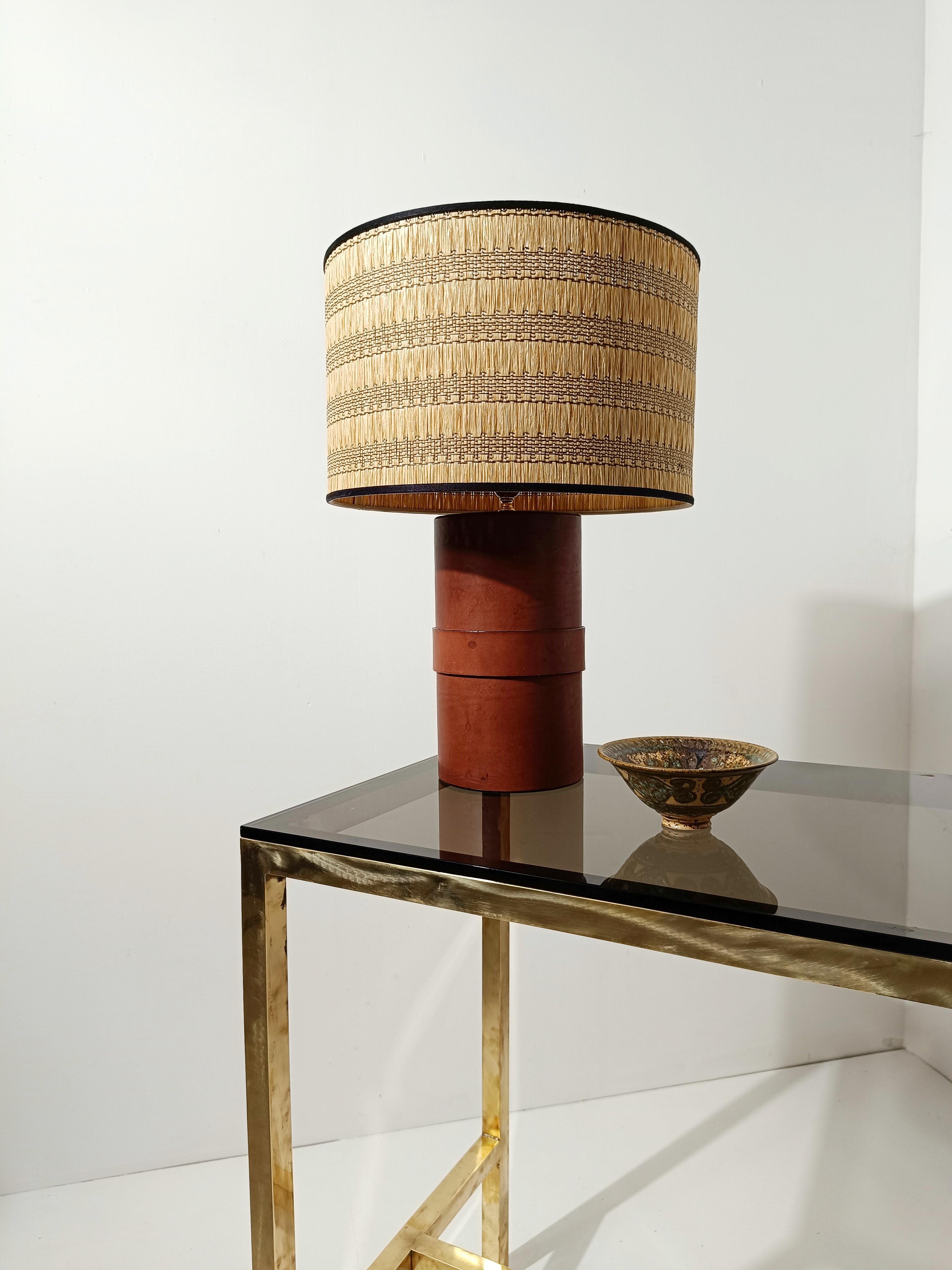 A table lamp made in Italy, as attested by the engraving on the leather at the base, by the company 