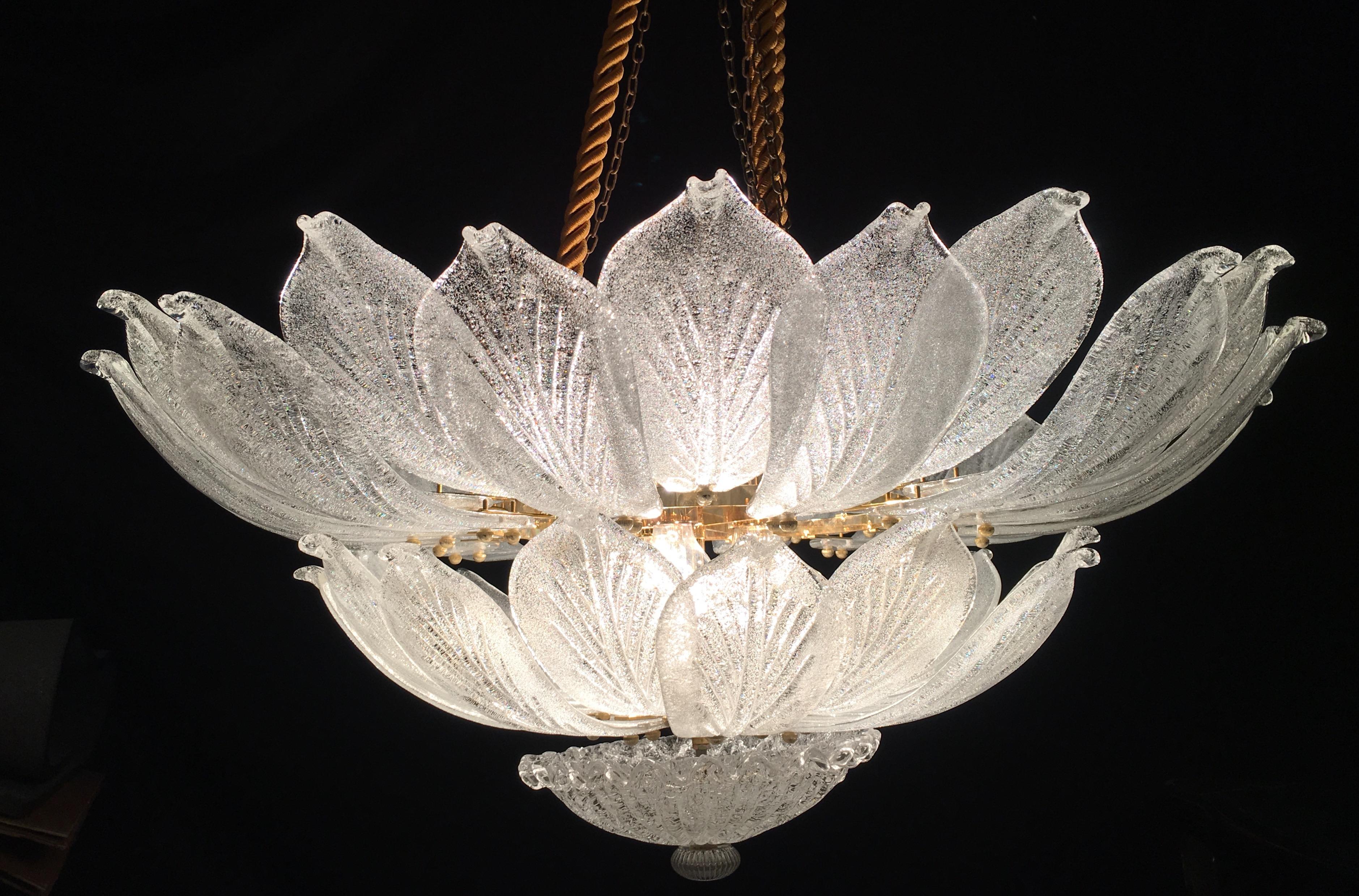 This striking ceiling light is realized in pure Murano glass, each chandelier consists of an incredible number of leaves with gold intrusion.
Gold-plated frame with 12 E 27 bulbs spread a magical light.
Available also a pair.
By Galleria