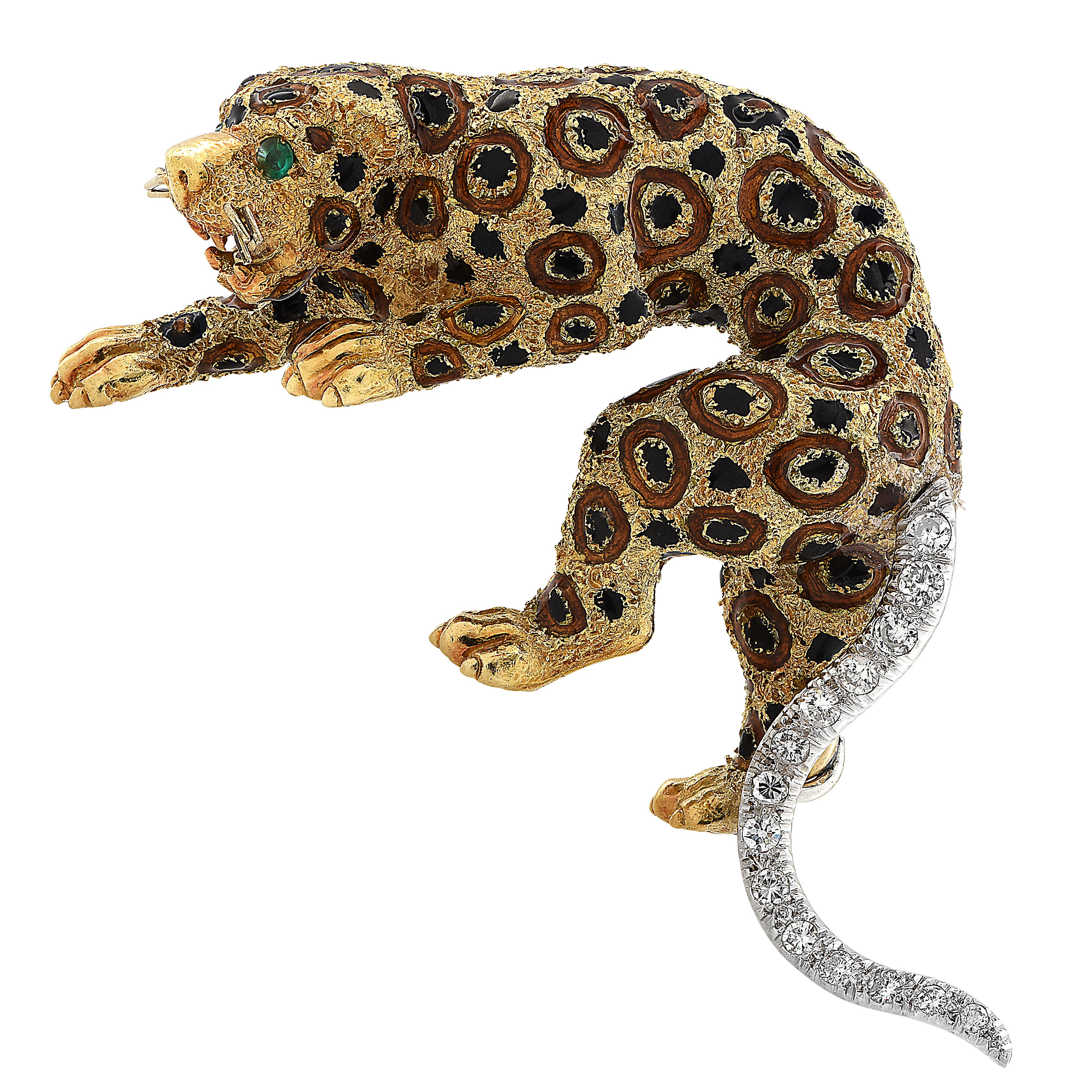 Captivating Leopard Brooch crafted in 18 karat yellow gold, accented with green emerald eyes and black and brown enamel spots, and a diamond encrusted tail featuring 14 round brilliant cut diamonds weighing approximately 1 carat total, F-G color and