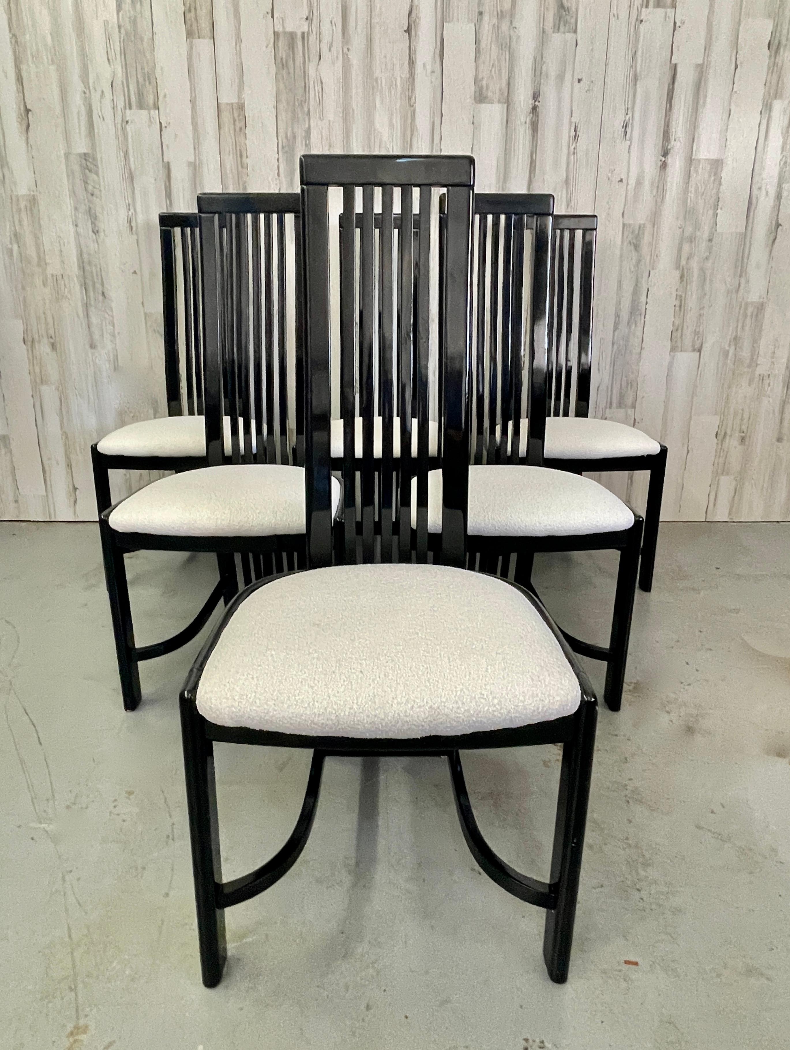Black Lacquer Italian Liberty Furniture Industries dining chairs. Each chair has a sleek curved back and are recovered in a very nice white boucle fabric.