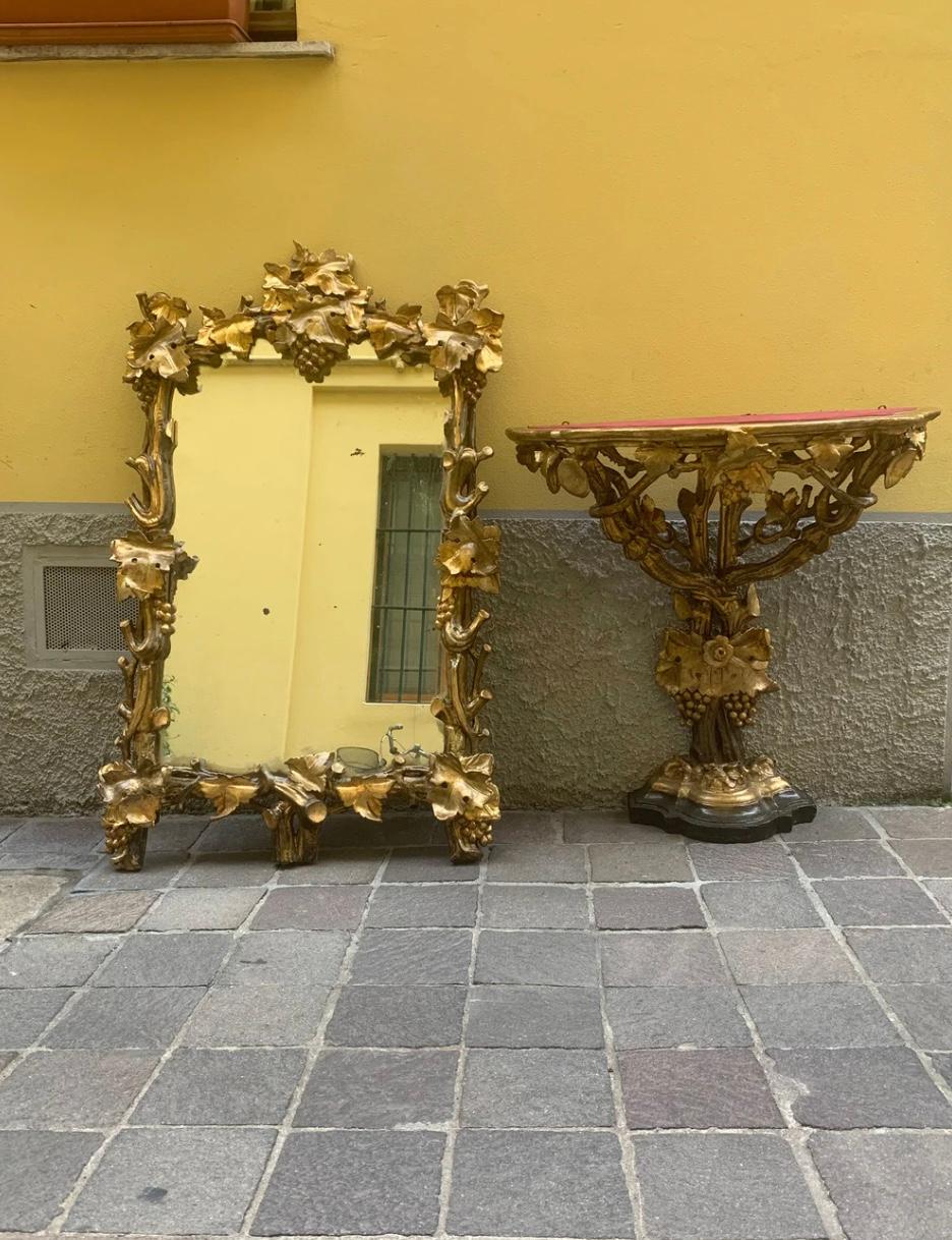 Italian Liberty table wood console with sculpted wall mirror in gilded wood, made in early XX century

Here are the dimension:

Wall Mirror: Ø 90 cm H 140 cm

Table Console: Ø 90 cm H 94 cm

This is a precious Italian masterpiece, made of