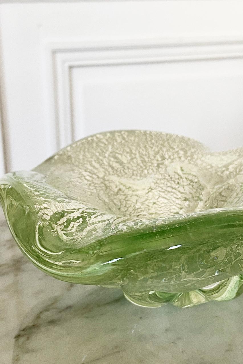 Italian light green Murano glass bowl with Aventurine silver flecks. Italy, 1950
Rare and beautiful centerpiece ashtray/bowl in Murano glass.
Incredible example of midcentury Italian Murano glass.

What is Murano Glass? Is it glass made in a special
