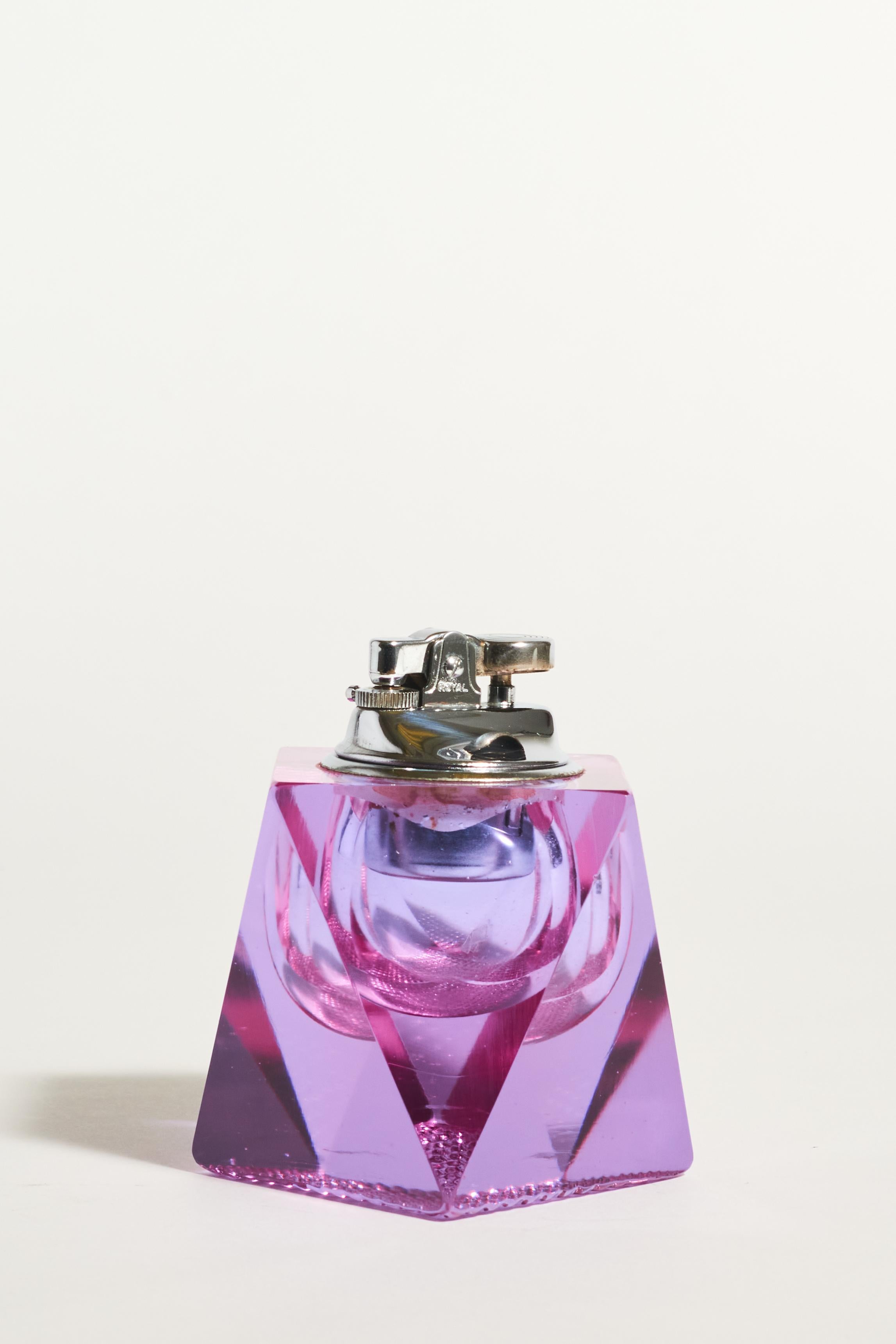 Italian lighter in geometric faceted lilac glass. 

*Lighters cannot be shipped with fluid inside because it is considered a hazardous material, but we have taken the lighter in to get checked and were told it could be in working condition if you