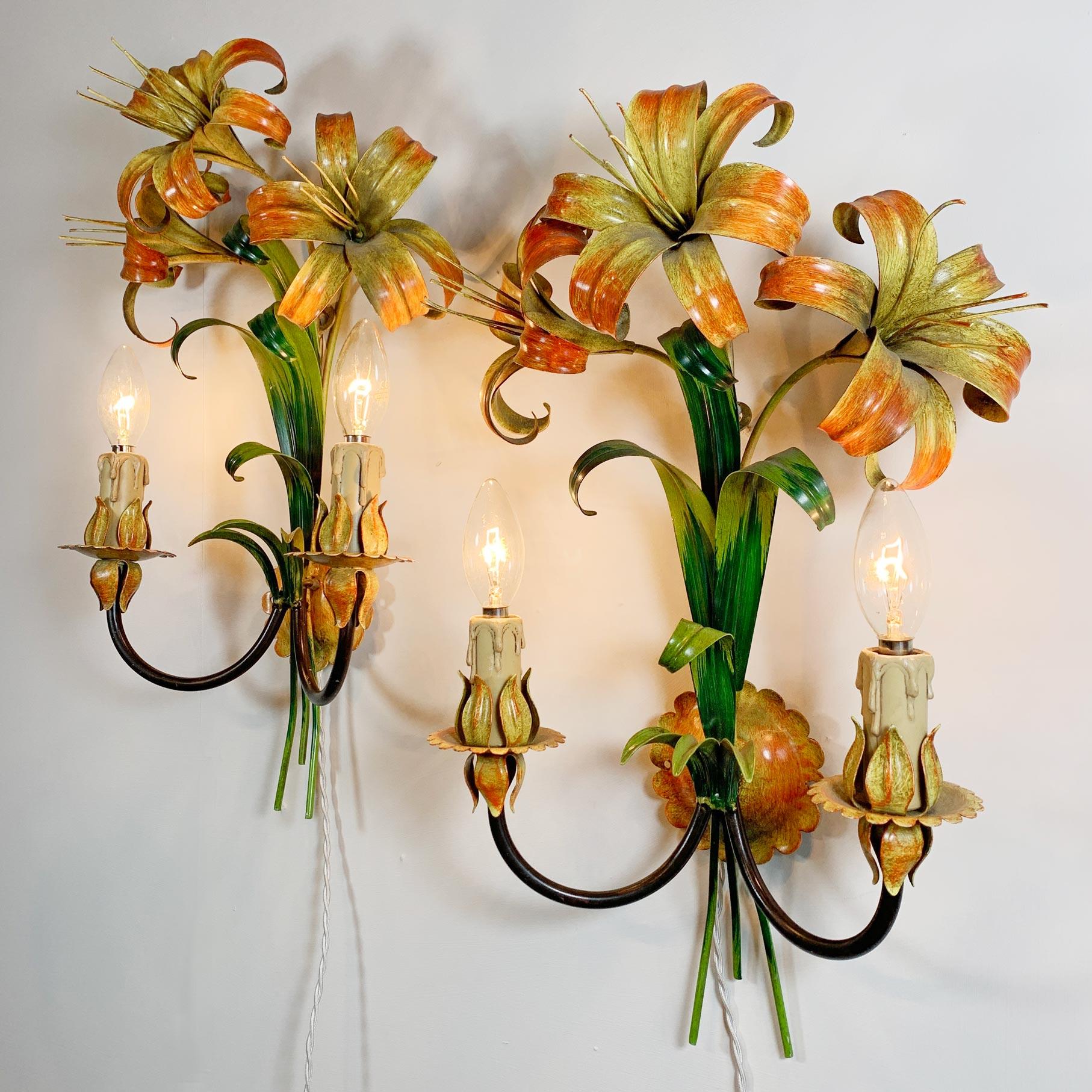 A colourful pair of hand painted Lily flower and leaf tole wall lights. In superb vintage condition, these 1970's lights are in full working order and PAT Tested. 


Price is for the pair.

Each light has two B15 (small bayonet) lamp