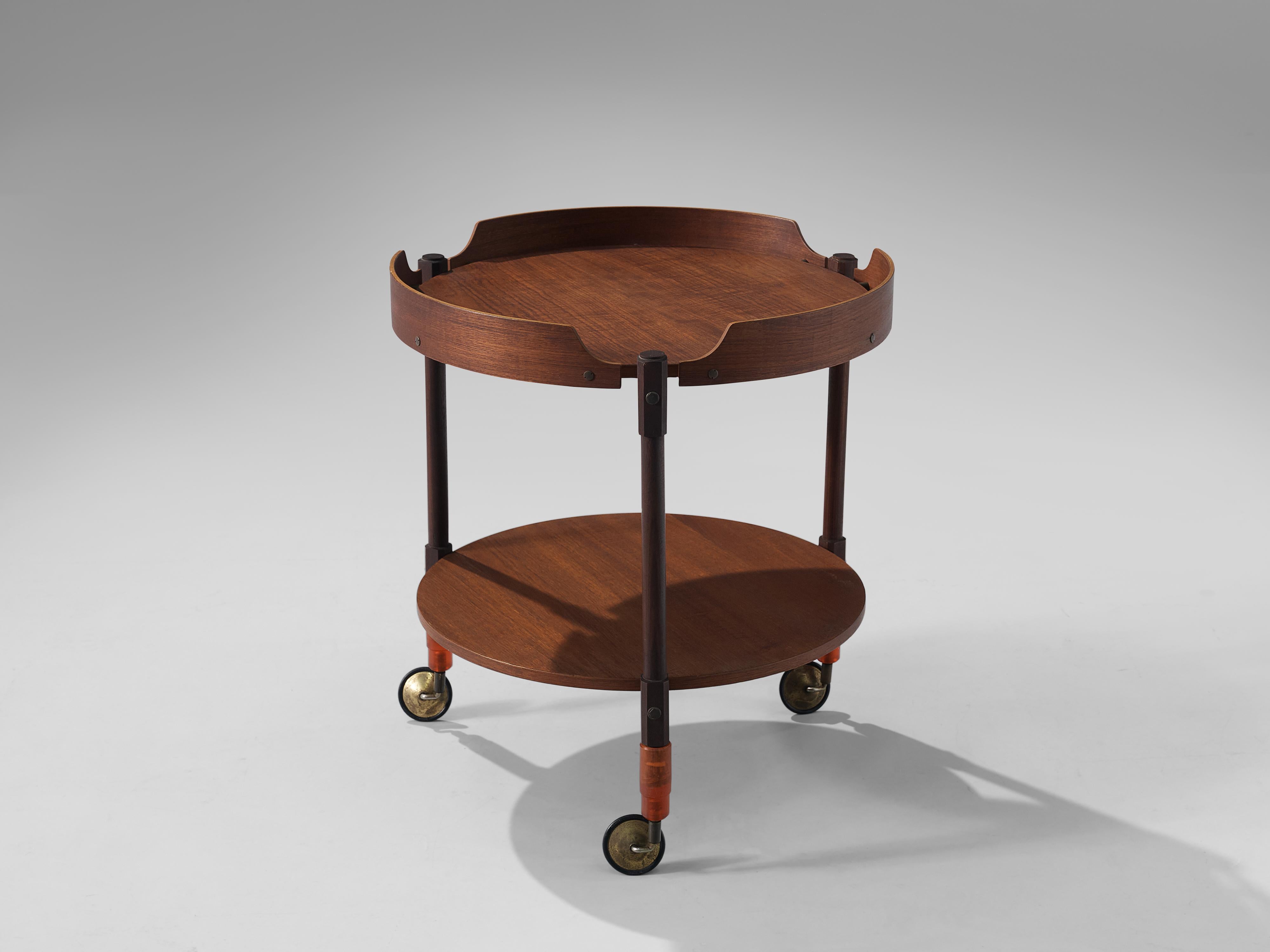 Liquor trolley, teak, brass, Italy, 1960s

Elegant liquor trolley in teak. The trolley has two layers that can be used for storage or serving functions. Due to the warm color of the teak in combination with the brass, the trolley has lovely