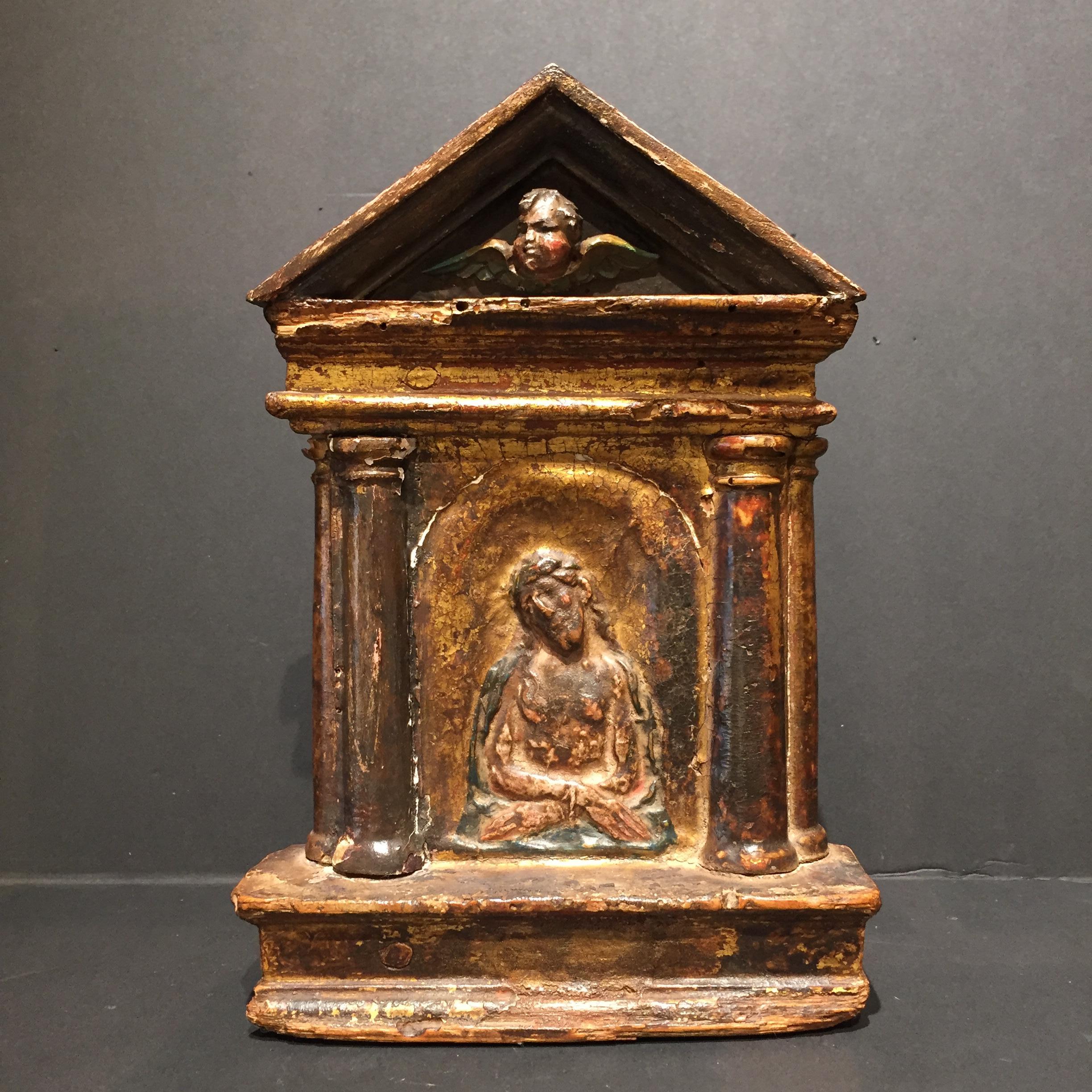 Italy
16th century

A liturgical Pax Brede or Osculatorium. The carved wooden board “Kiss of Peace” representing Christ as a man of sorrows. The pax has the shape of an ancient temple. Christ is placed in a niche between four balusters. The upper