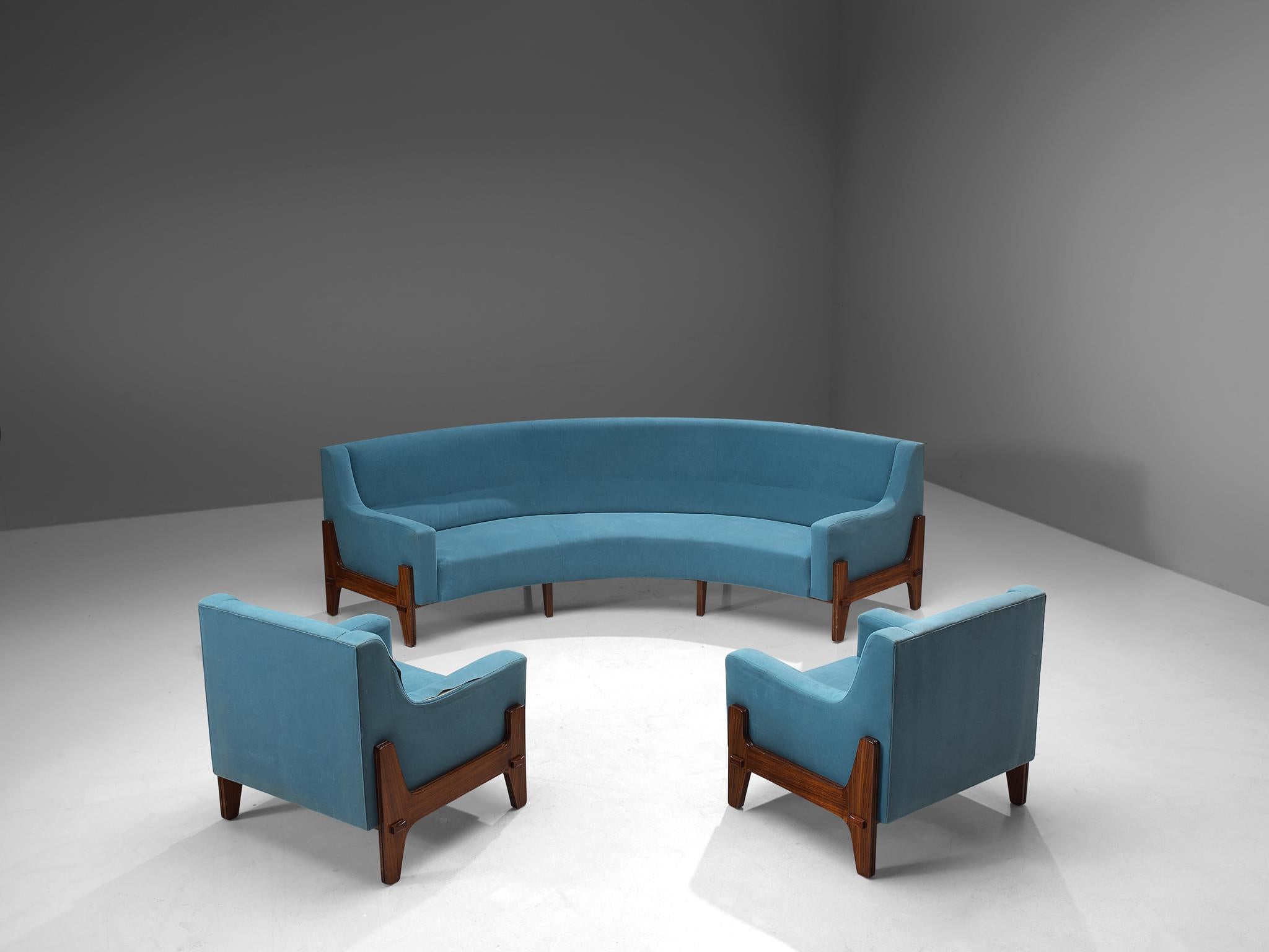 Eugenia & Luigi Reggio, lounge set, rosewood and fabric, Italy, 1950s.

This Italian lounge set, consisting of a curved sofa and two lounge chairs, feature a sturdy frame made of rosewood that is beautifully exposed on the outside of the seat.