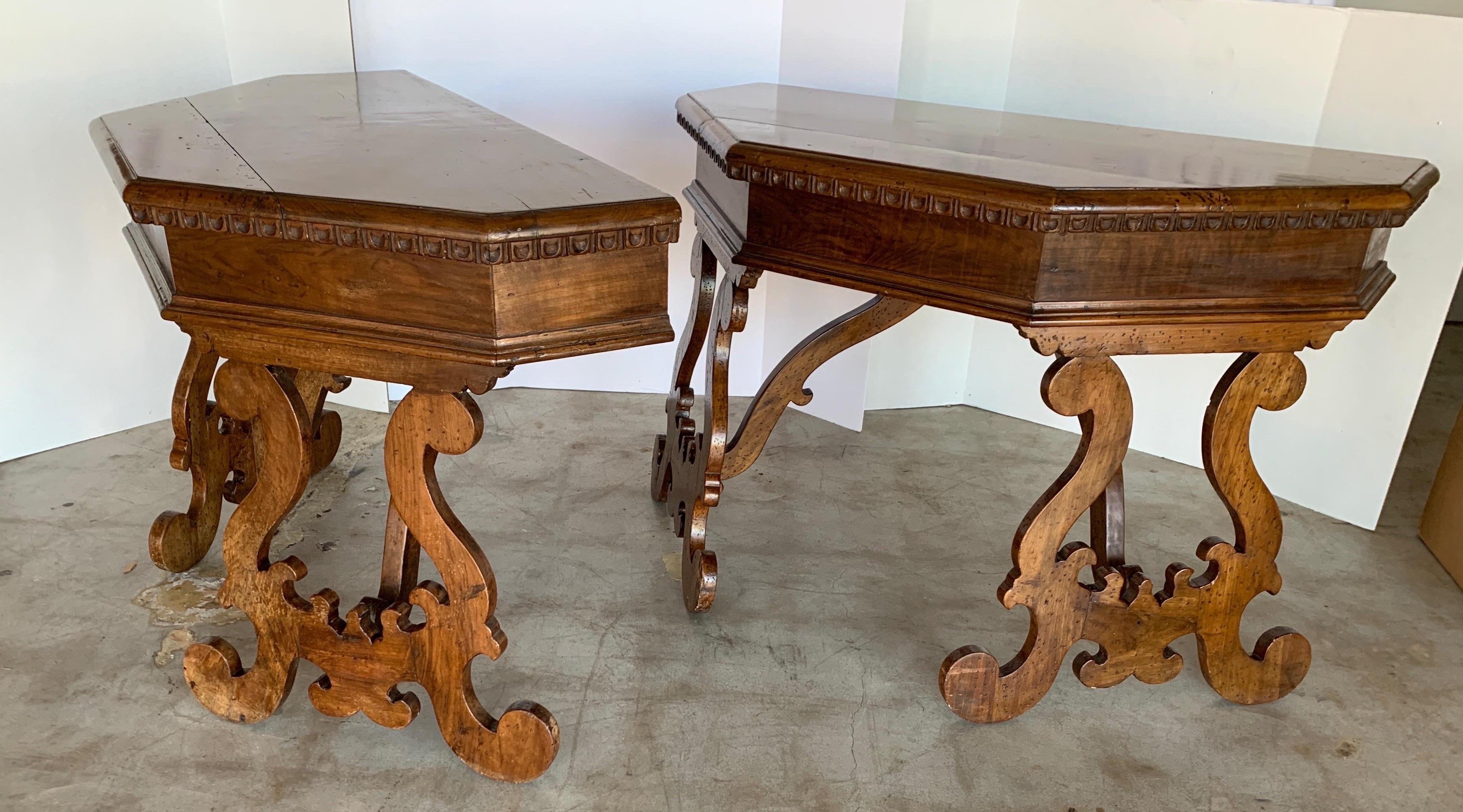 These tables have a handsome warm walnut patina. The were ends to a dining table at one time as the metal is still on the underside where it held the dowel to hold it together. It originates from Lombardi, Italy and is from the 1800s. You can