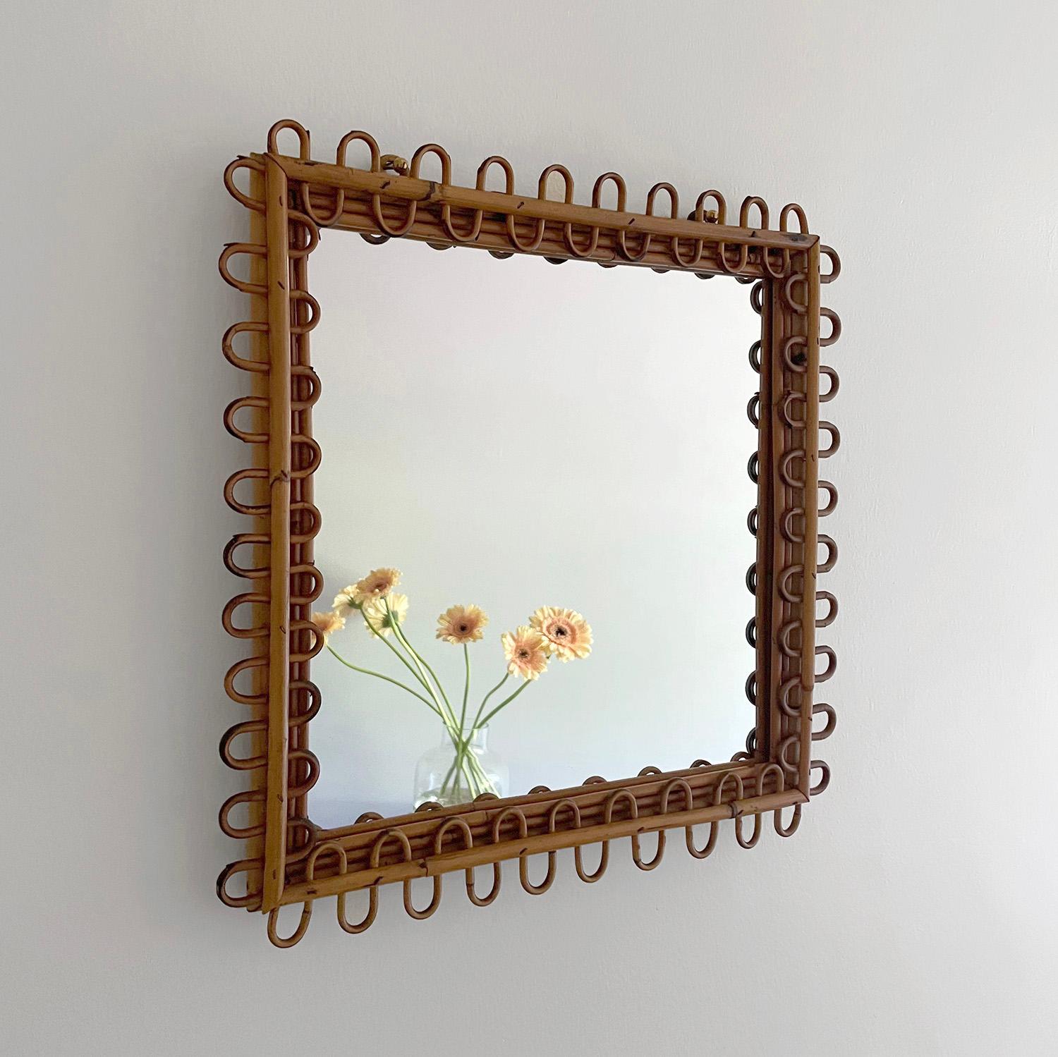 Italian rattan square wall mirror
Italy, circa 1950’s
Whimsical looped rattan frame
Natural color variations throughout the rattan
Two rattan loops for wall mounting
Original mirror light surface markings
Patina from age use