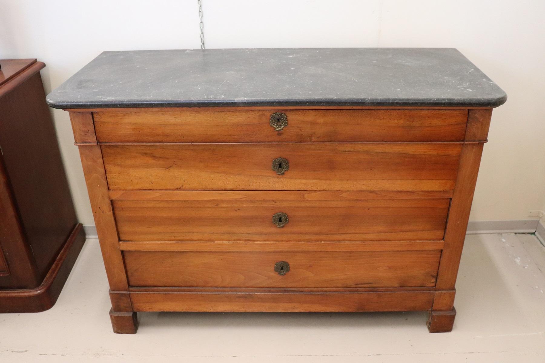 Rare and fine quality Italian Louis Philippe antique dresser, 1850s. Precious solid walnut wood. Equipped with four comfortable drawers. Top in fine Italian dark gray marble. Very simple and linear, perfect even in a modern furniture. Used but