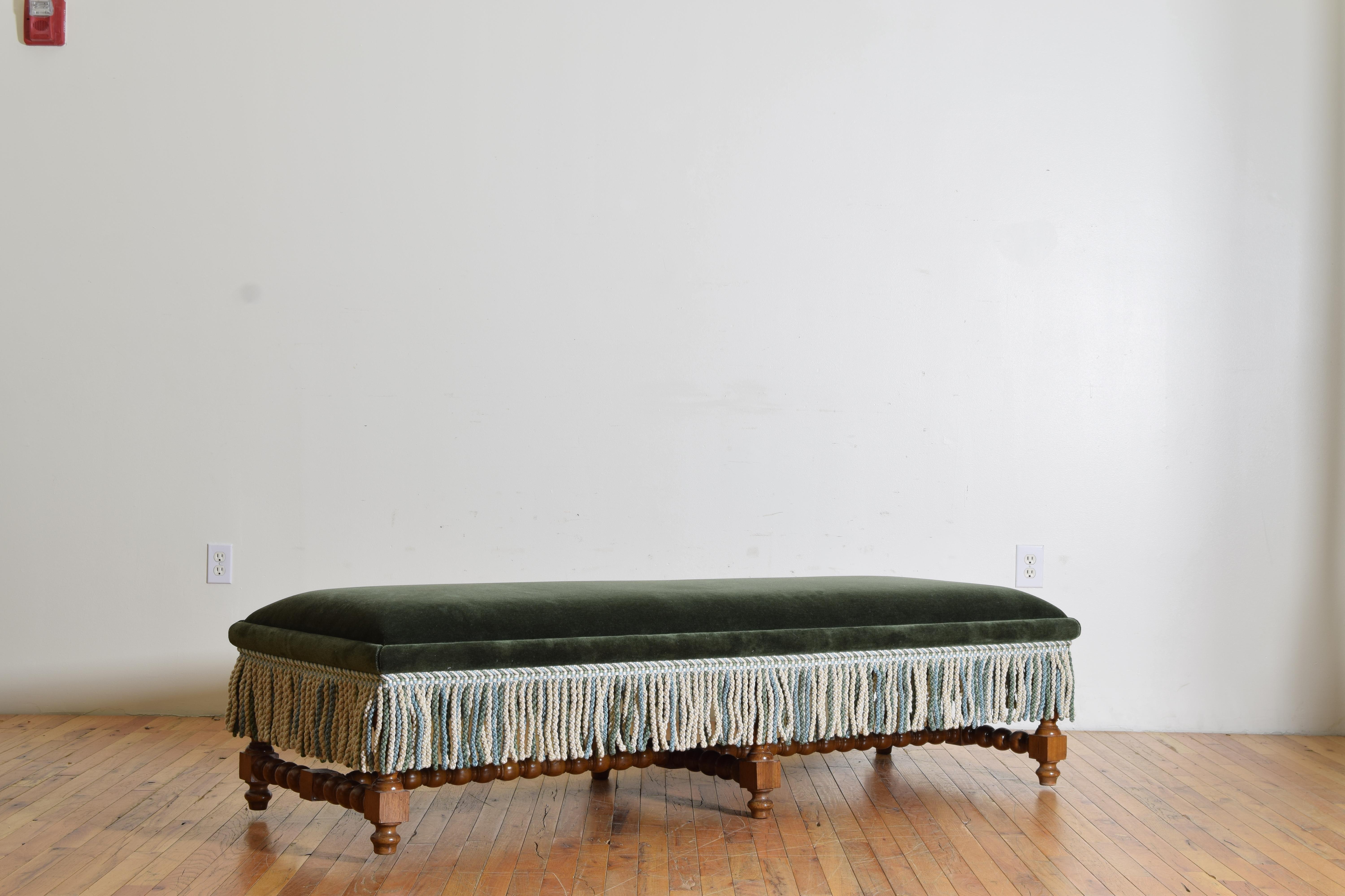 Having a mohair upholstered seat with fringed decoration, the frame of lights walnut with turned legs joined by an double h-form stretcher