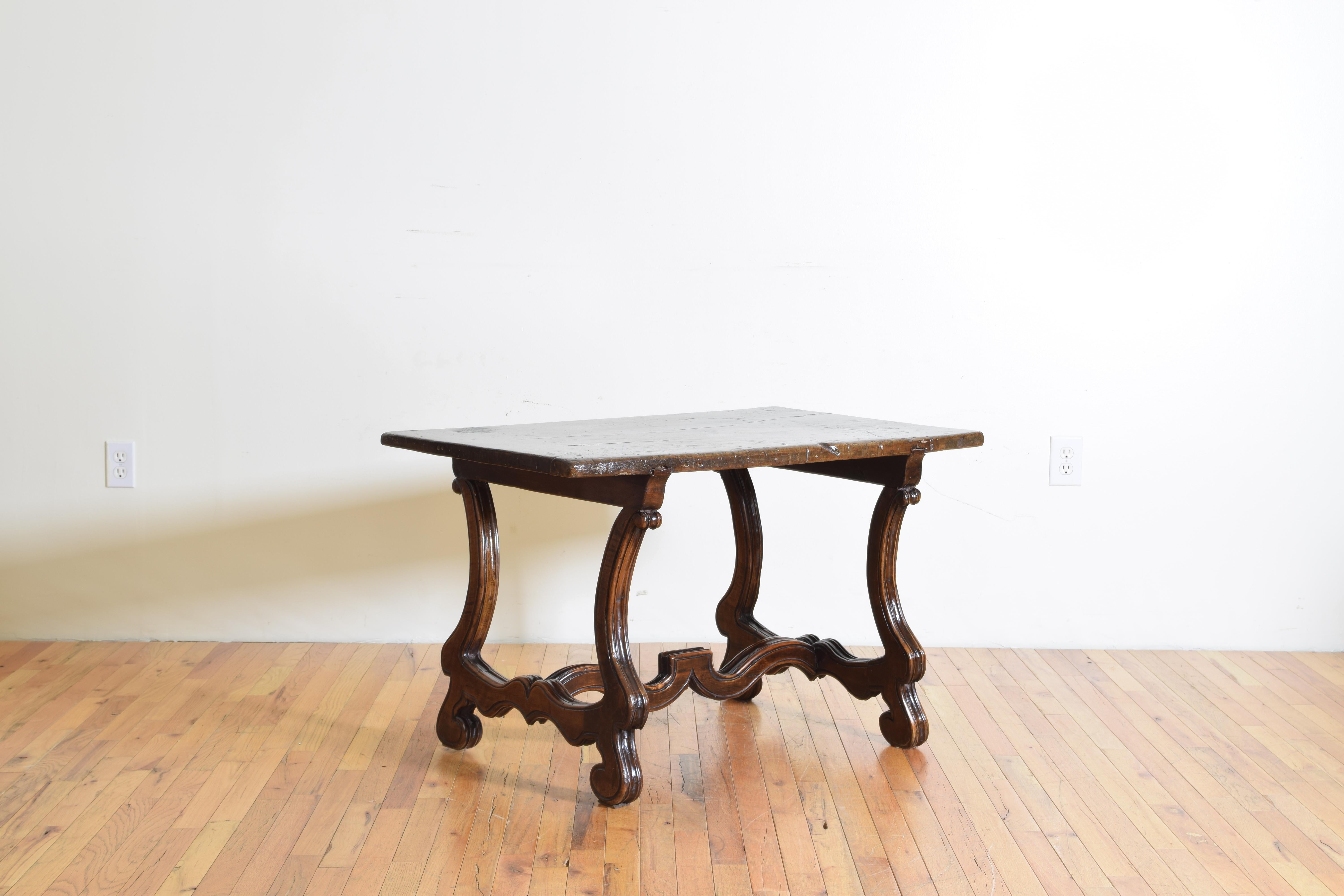 Combining antique elements from the early 18th century this table has a rectangular top raised on carved legs and a shaped stretcher, the legs and stretcher of the French Os de Mouton style popular in the first half of the 18th century.