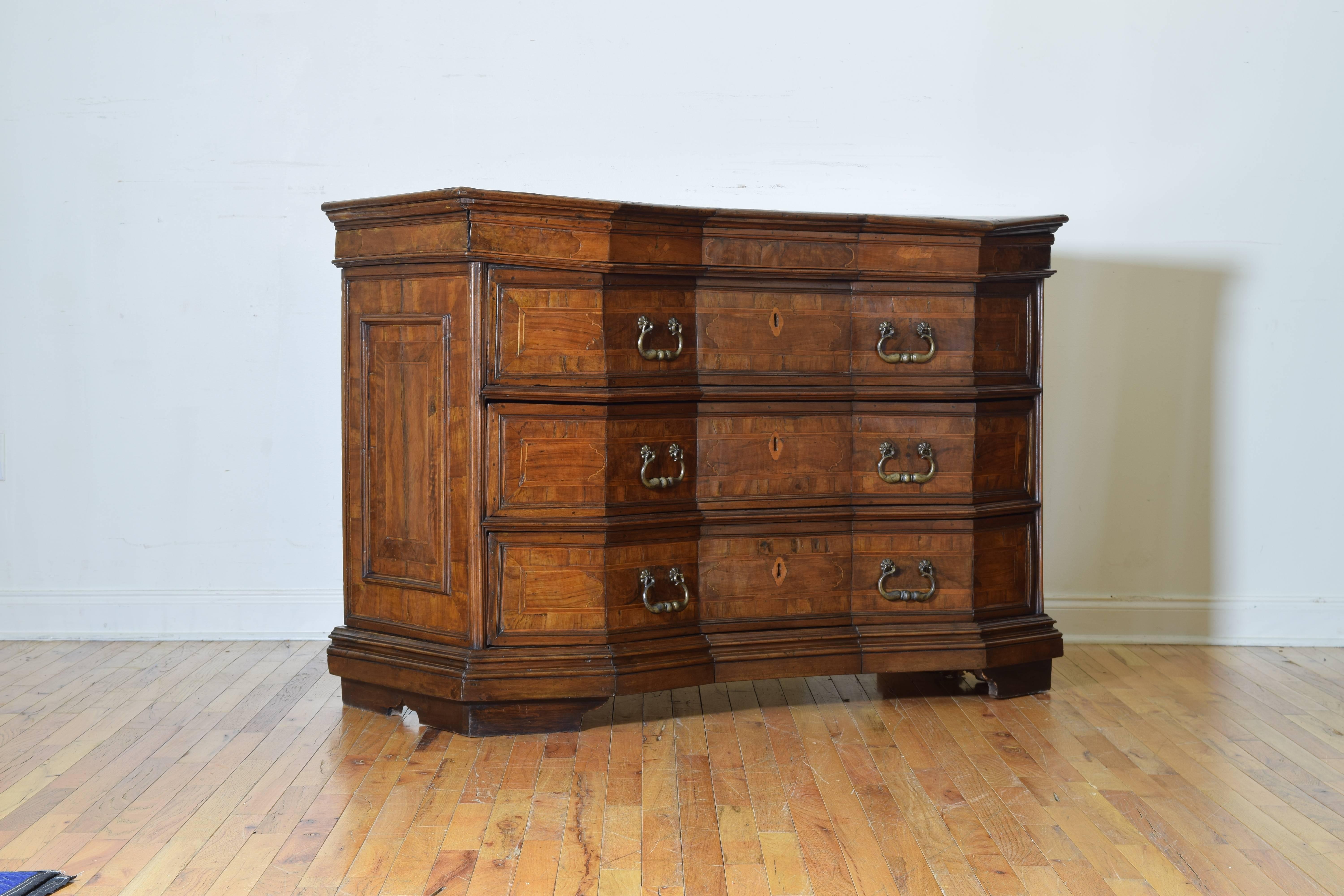 North Central Italy, cantarano commode, entirely veneered notched (scantonata) front with three drawers plus one hidden below the top, paneled sides, raised on a plinth base and bracket feet.