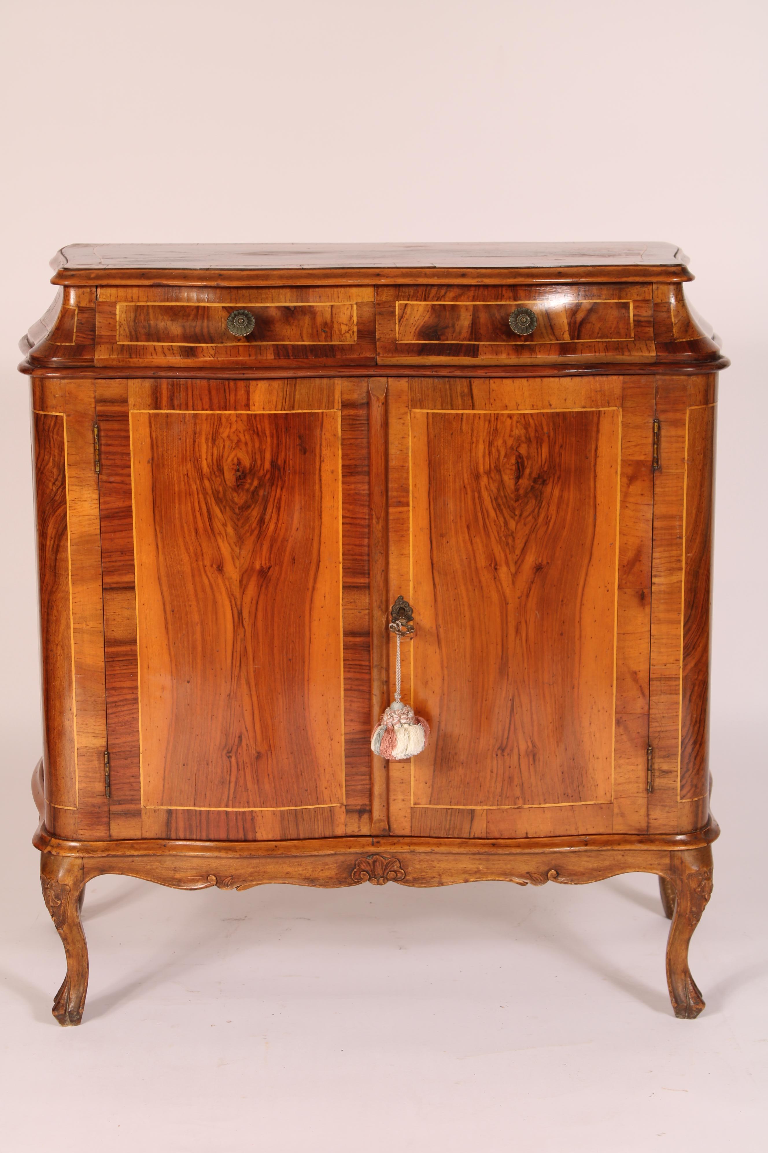Italian Louis XV style burl walnut cabinet, circa 1970's. With a burl walnut top with string inlay and burl walnut cross banding, two serpentine shaped drawers with string inlay and brass knobs, below are two burl walnut doors each serpentine shaped