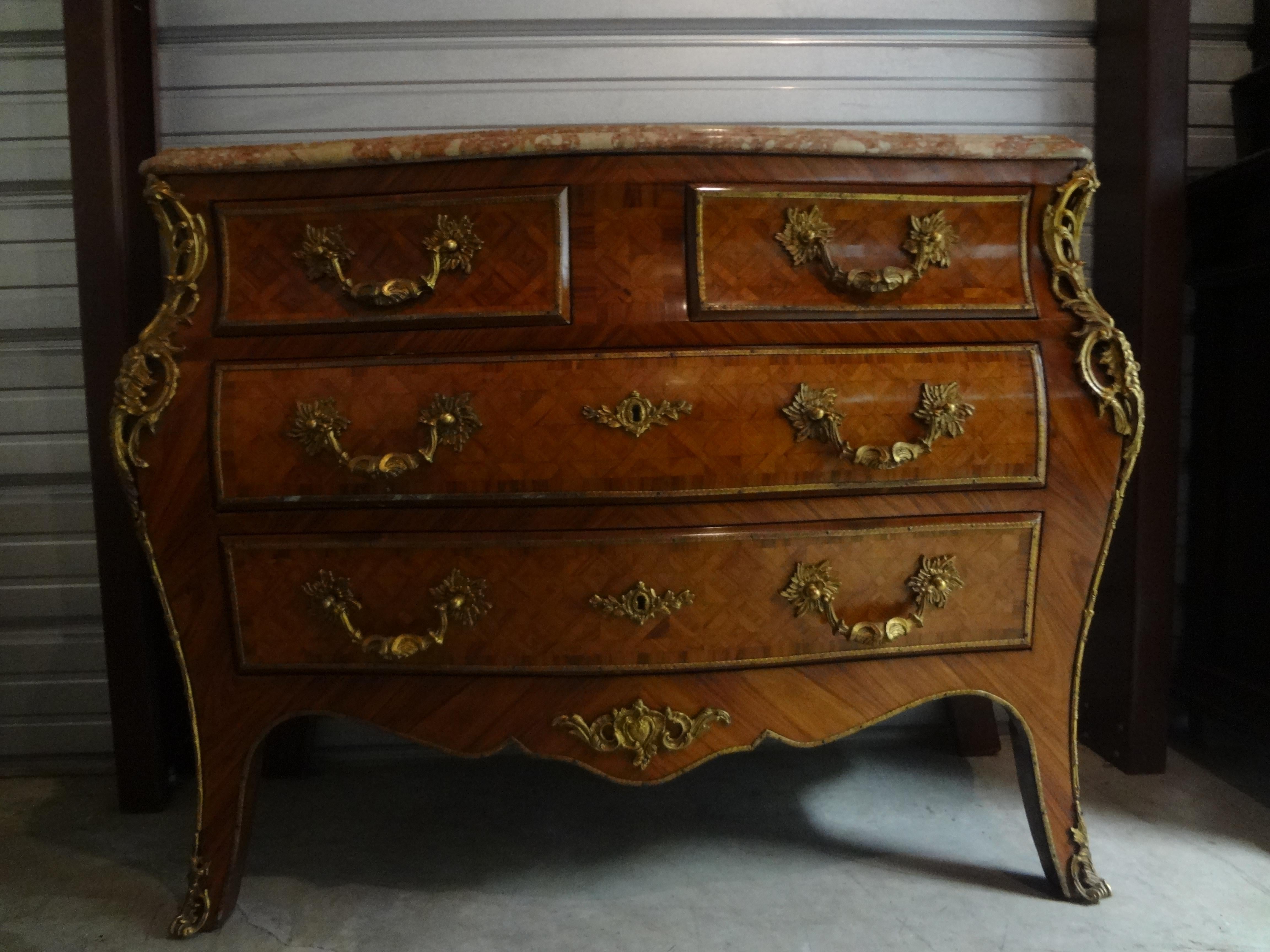 Stunning Italian Louis XV style marquetry commode or credenza with bronze hardware and its original marble top. Our antique Italian chest in the French Louis XV style has two large drawers below with two smaller drawers above. This beautiful Italian