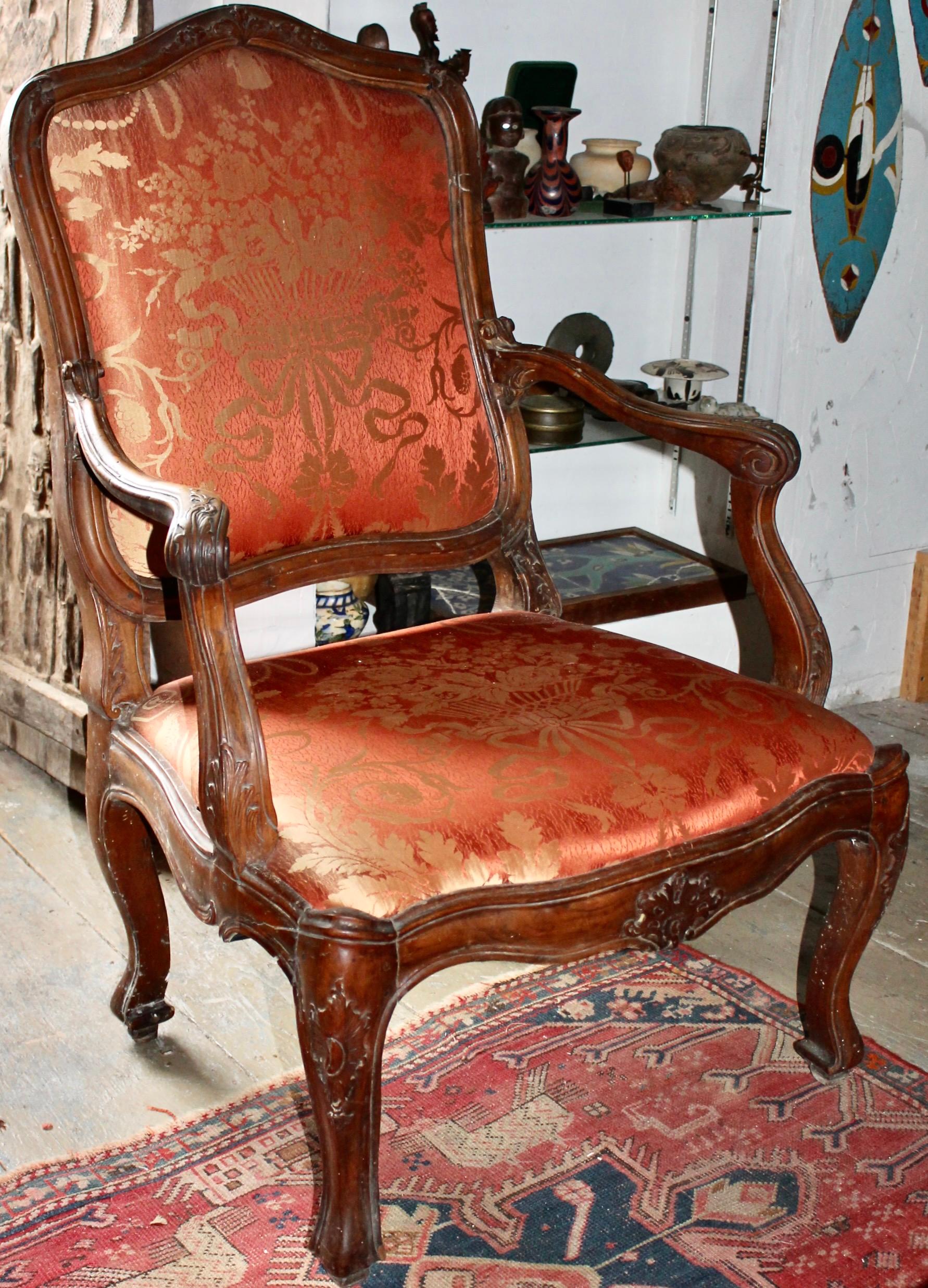 A large beautifully carved Walnut Armchair, Italian late eighteenth century in Louis XV style. Reupholstered.