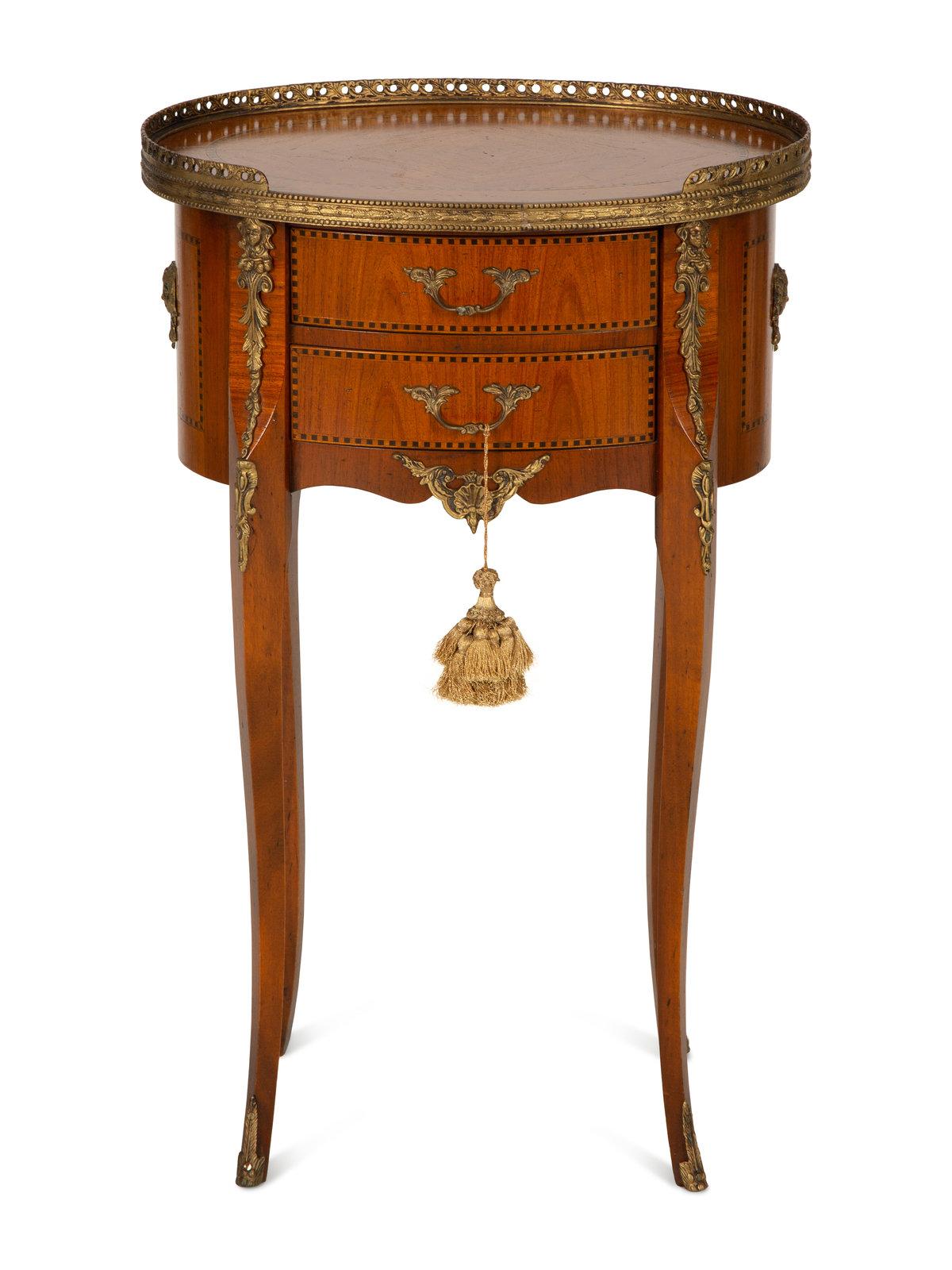Italian Louis XV/XVI Transitional style gilt metal mounted fruitwood side table with a brass gallery and two drawers, 20th century bearing a Baggio Annico label and numbered 8205 to the underside of the lower drawer. Measures: Height 27 1/8 x width