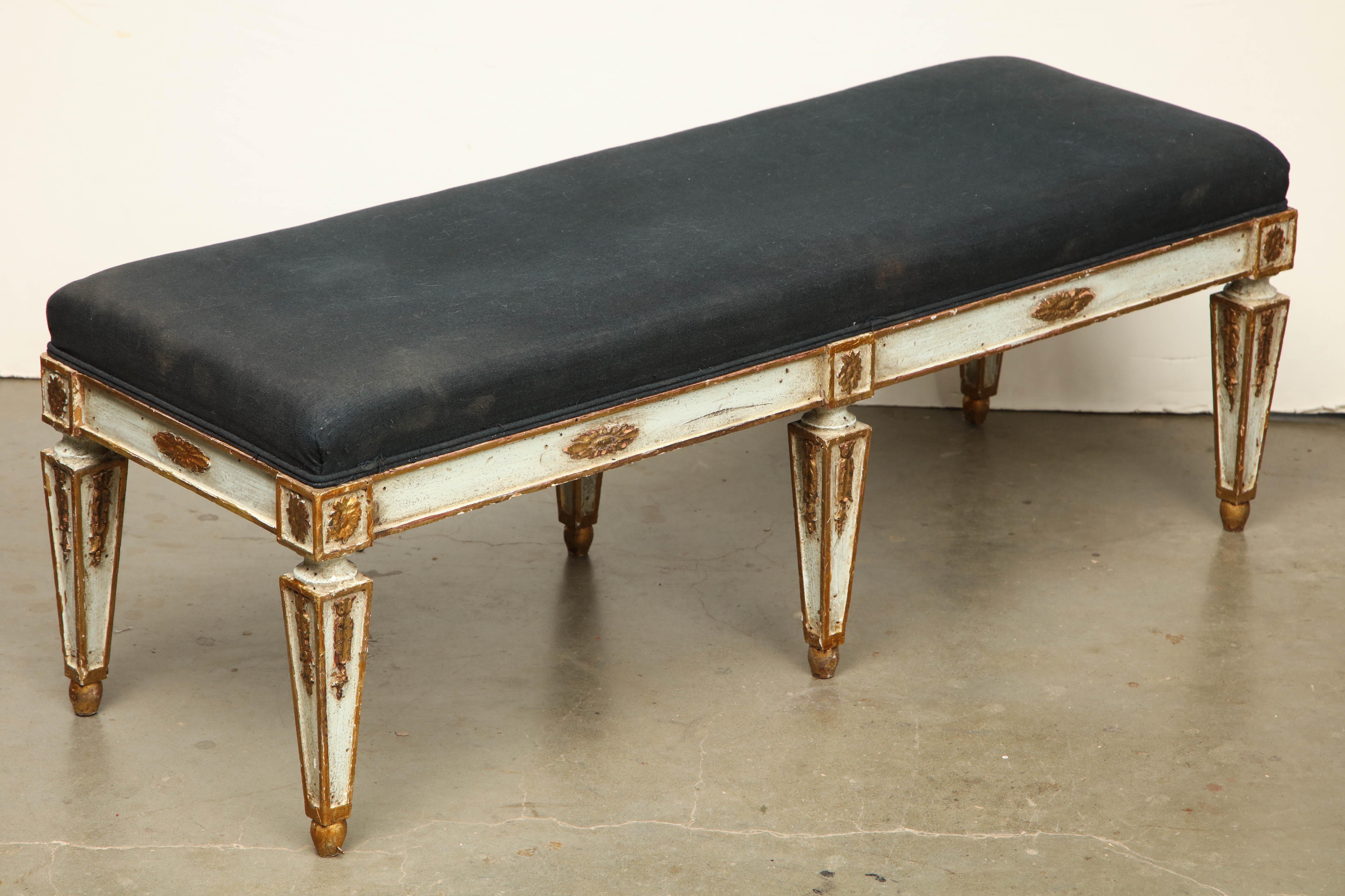 Italian Louis XVI carved parcel-gilt six-legged banquette with upholstered cushion seat.