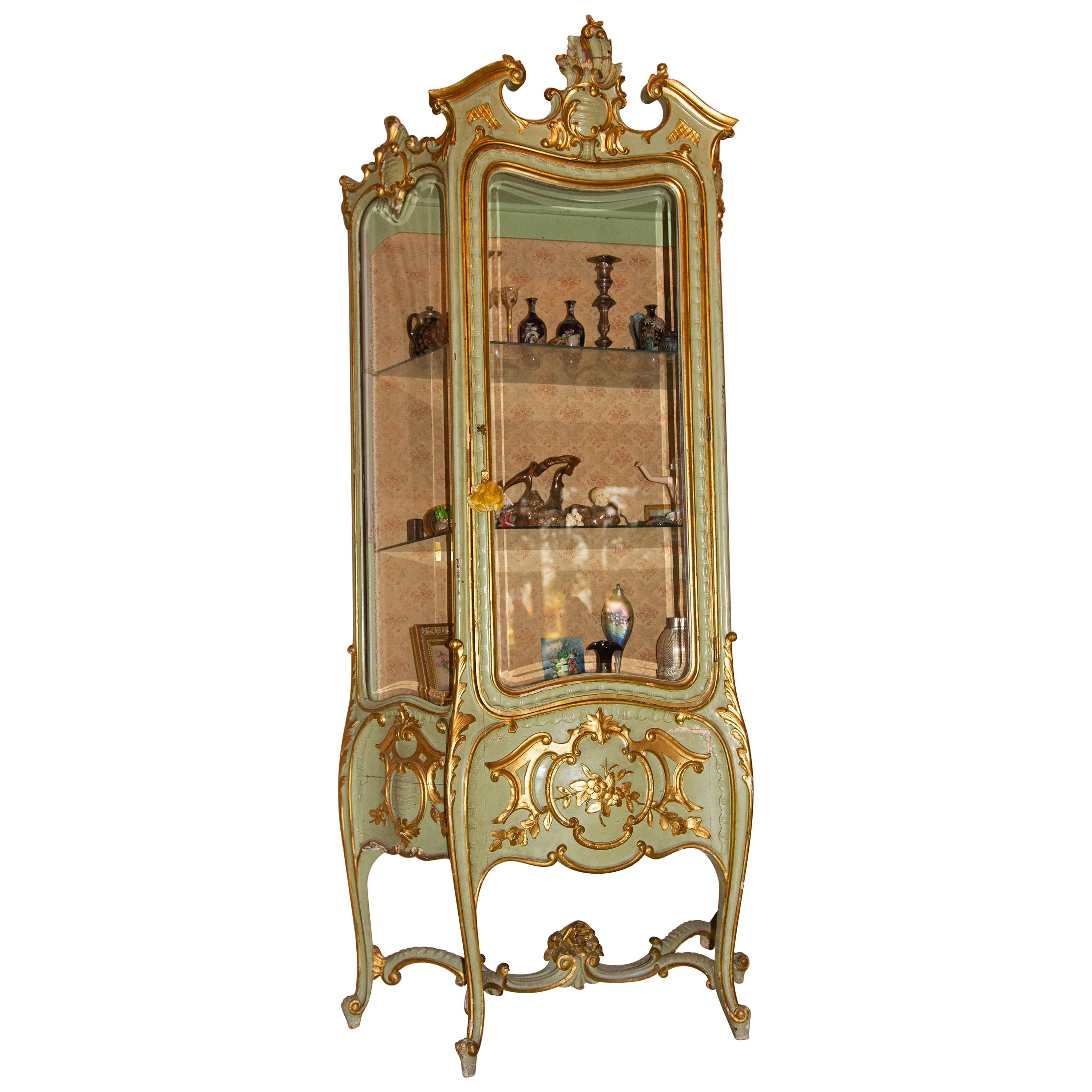 19th century Italian painted parcel-gilt beveled glass curio cabinet. Carved wood. Louis XVI style. One of several items we are selling from a living estate.
 