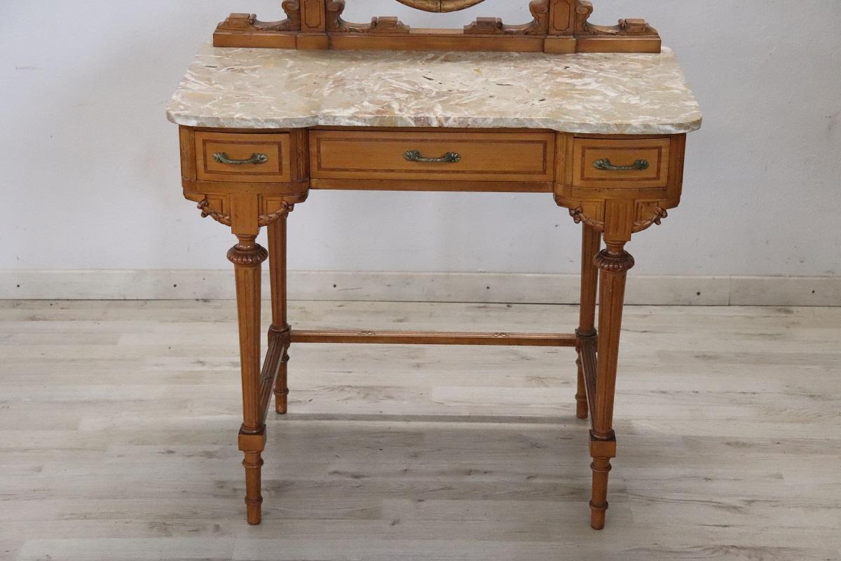 Superb dressing table for bedroom. Particular shape in perfect Louis XV style. Made of fine cherry with refined small carved decorations. The top is in refined light-toned marble. The oval mirror with carved cherry wood frame. The handles are in