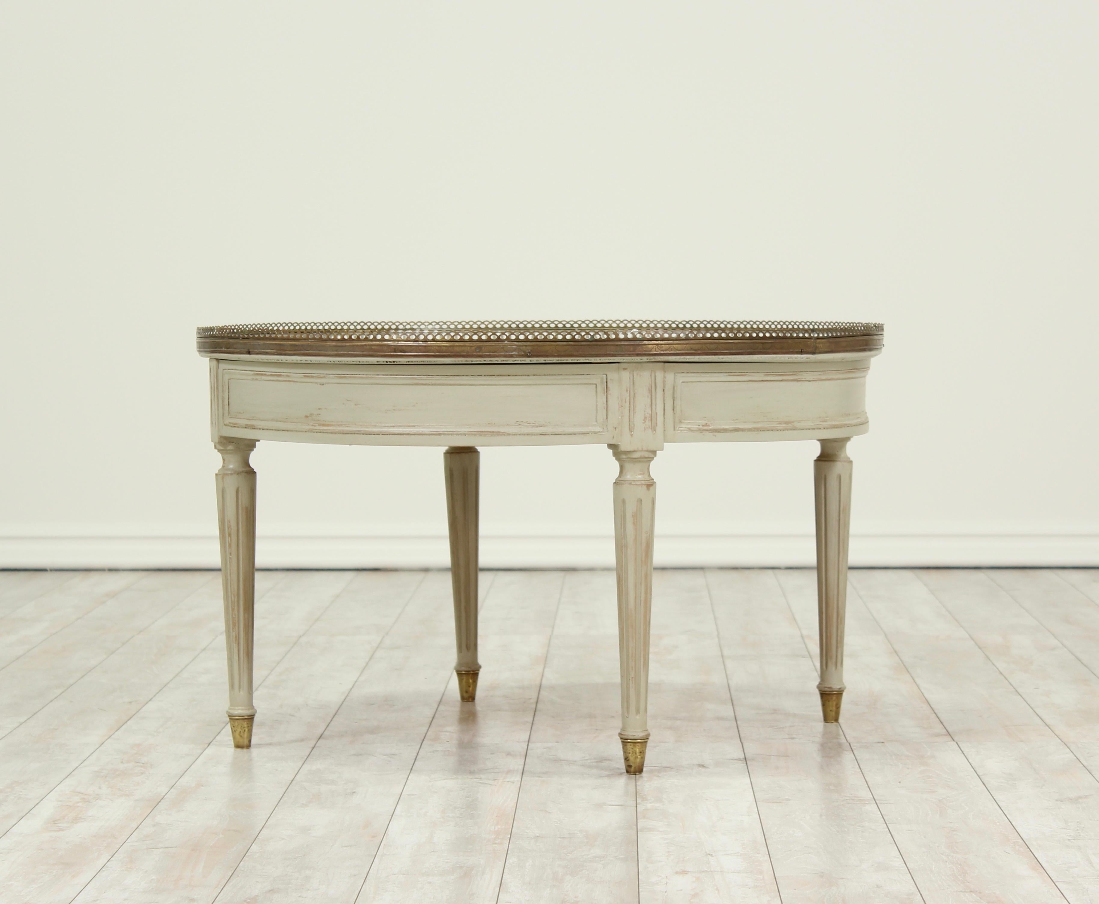 Beautiful, 1940s Italian Louis XVI Bouillotte style painted coffee table featuring a Calcutta gold marble top with a brass gallery and sabots.