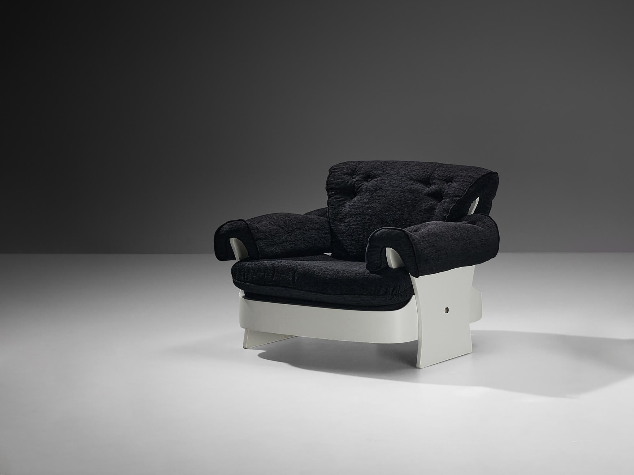 Lounge chair, plywood, fabric, Italy, 1970s

Armchair composed of white lacquered wood. The chair is build up from a square base with rounded edges and three large legs, one in the back and one at each side. The wooden parts are connected by metal