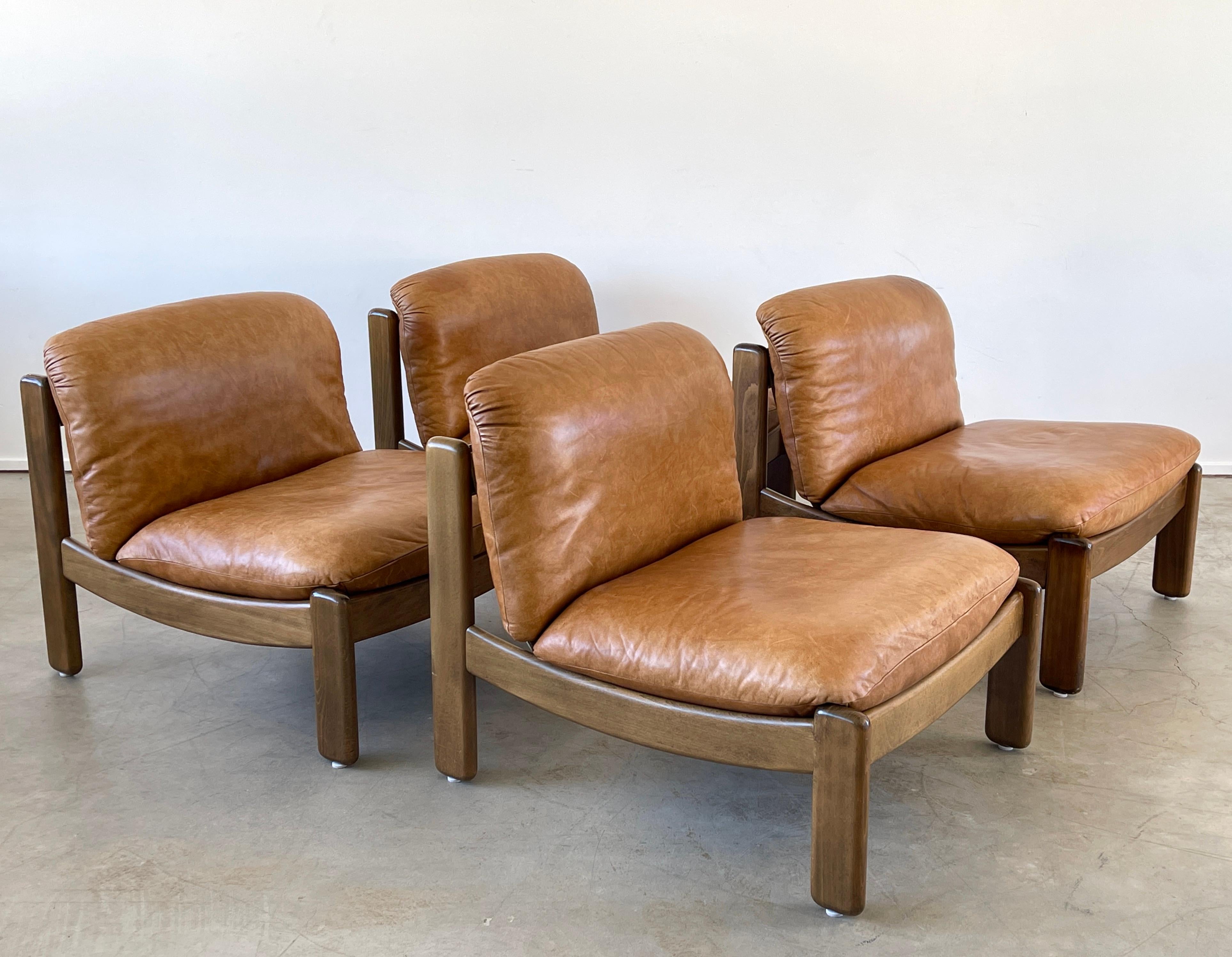 Great pair of Italian leather Lounge chairs with walnut frames in low linear shape 
Wonderful patina to leather and wood 
2 Pairs available /priced as a pair.