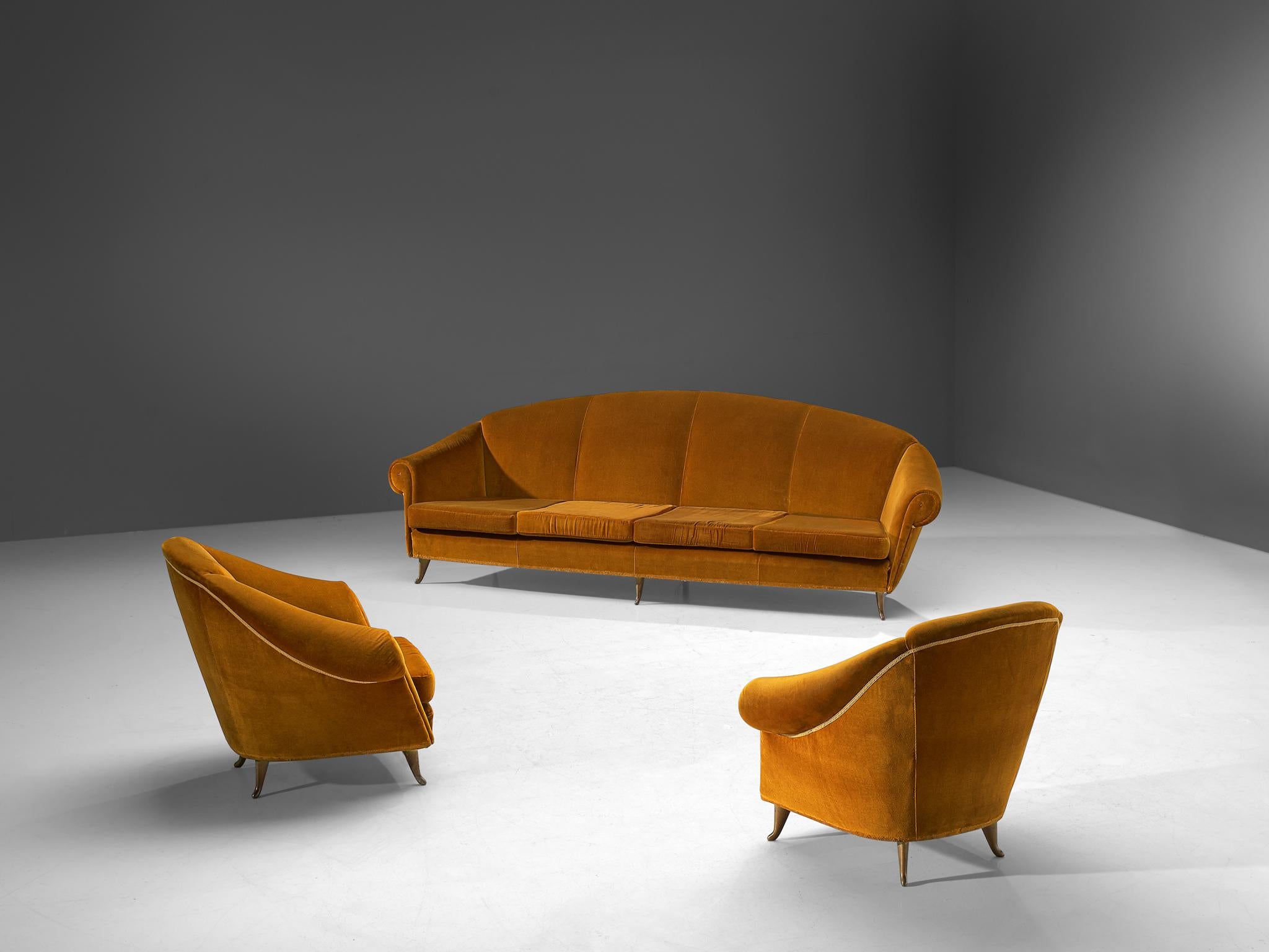 Living room set, velvet and brass, Italy, 1940s

This voluptuous, elegant set, consisting of a four-seat sofa and two lounge chairs, features high, to ascended backs that flow over to the thick, curled armrests. These features give these chairs
