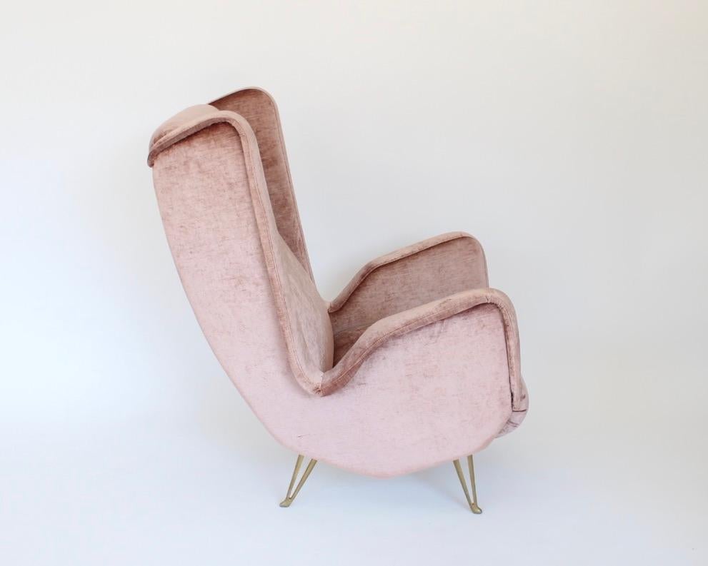 Italian Mid-Century modern hi-back lounge chairs or wingback armchair by ISA Bergamo and attributed to Gio Ponti signed and numbered ISA.. Recently re-upholstered in Italy. Italian lounge chair by ISA Bergamo reupholstered in a pale pink color silk