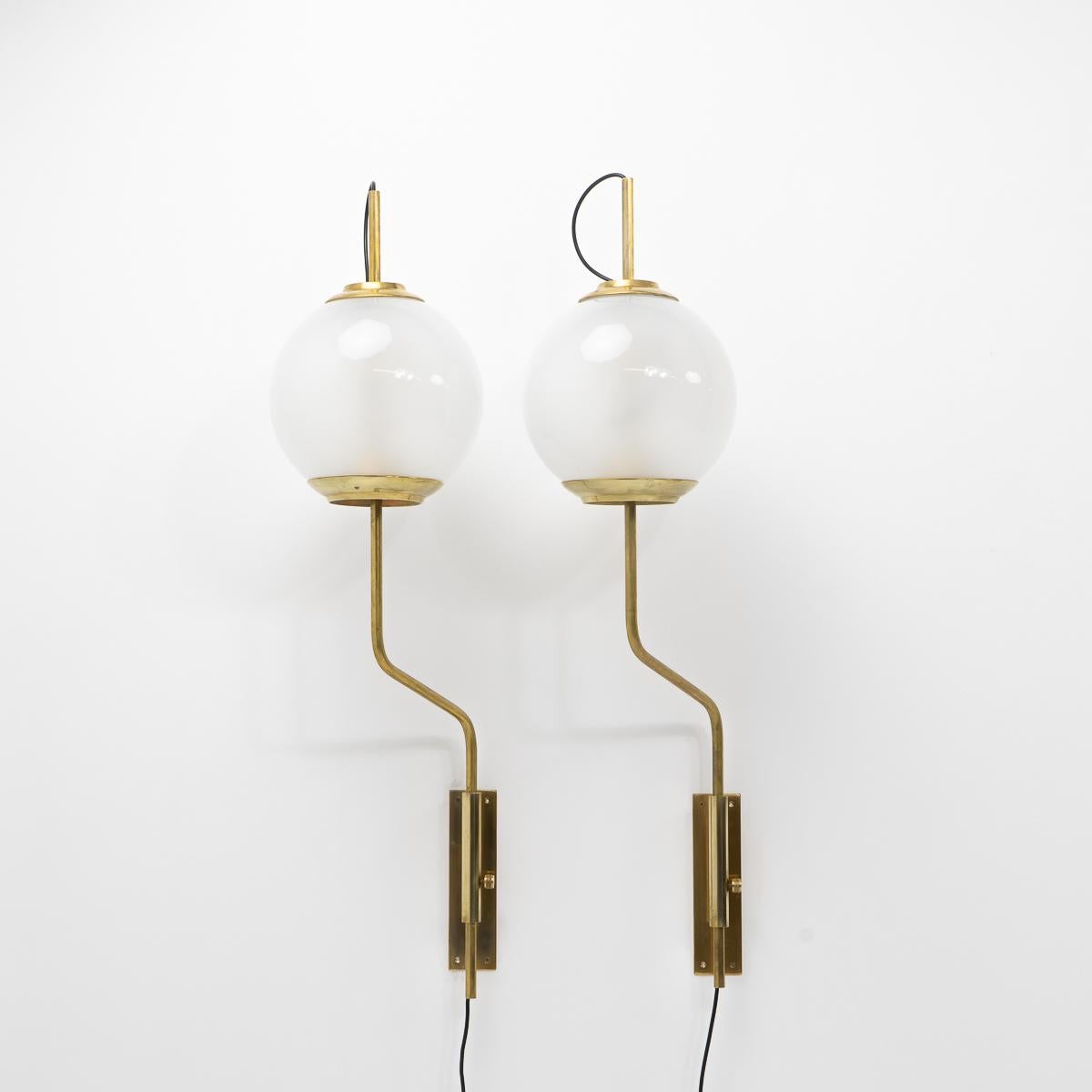 Set of two impressive adjustable LP11 “Pallone” sconces by Luigi Caccia Dominioni for Azucena originally designed in the late 1950s.

The lamps rotate and are height adjustable. Brass and opaline glass. 


Condition: Good vintage condition, signs of
