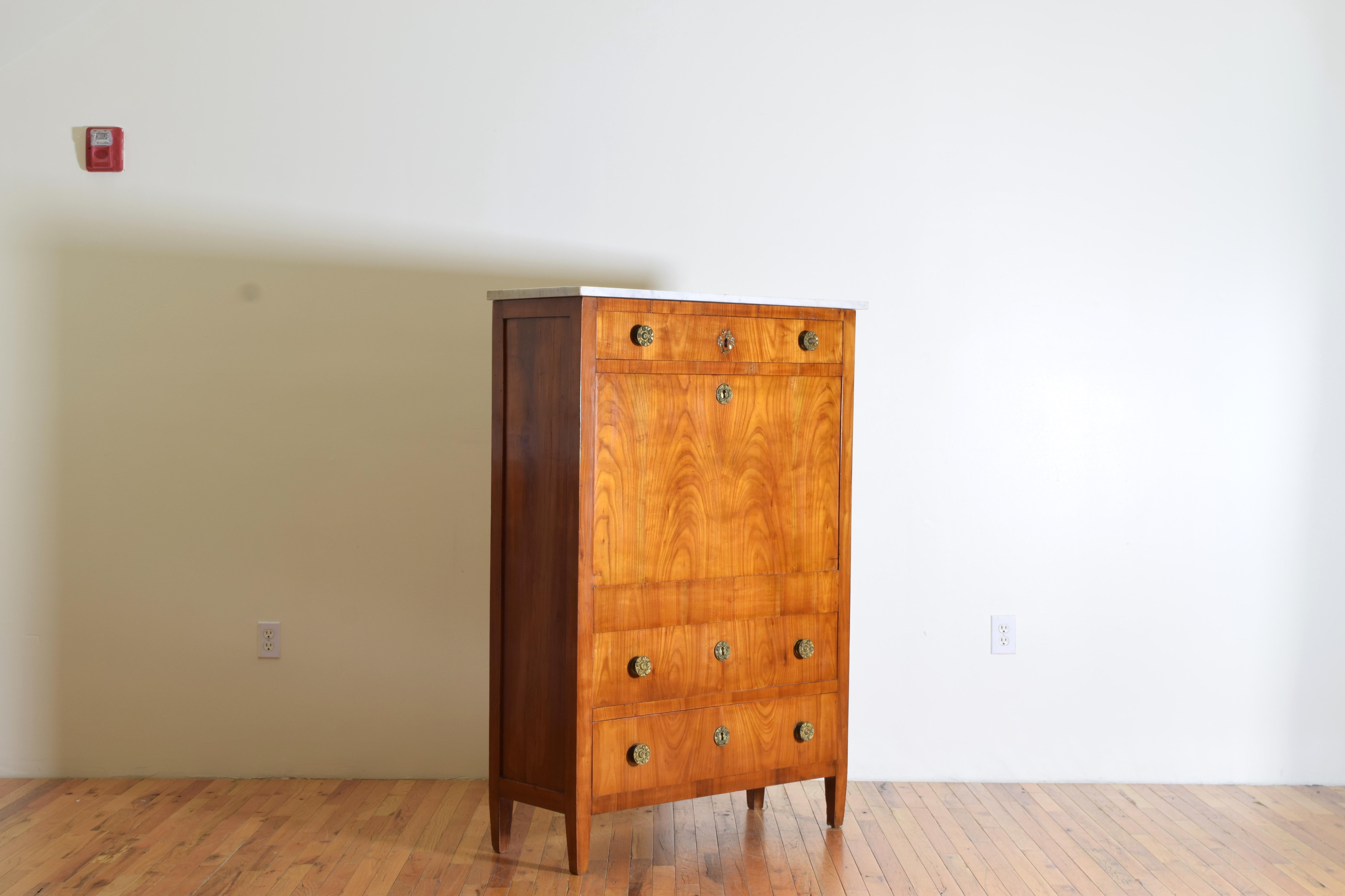 Of slender and rectangular form and constructed entirely of solid and veneered cherrywood this secretary cabinet comes from Lucca, Italy constructed in the Neoclassical period, having a Carrara marble top above a conforming case with paneled sides,