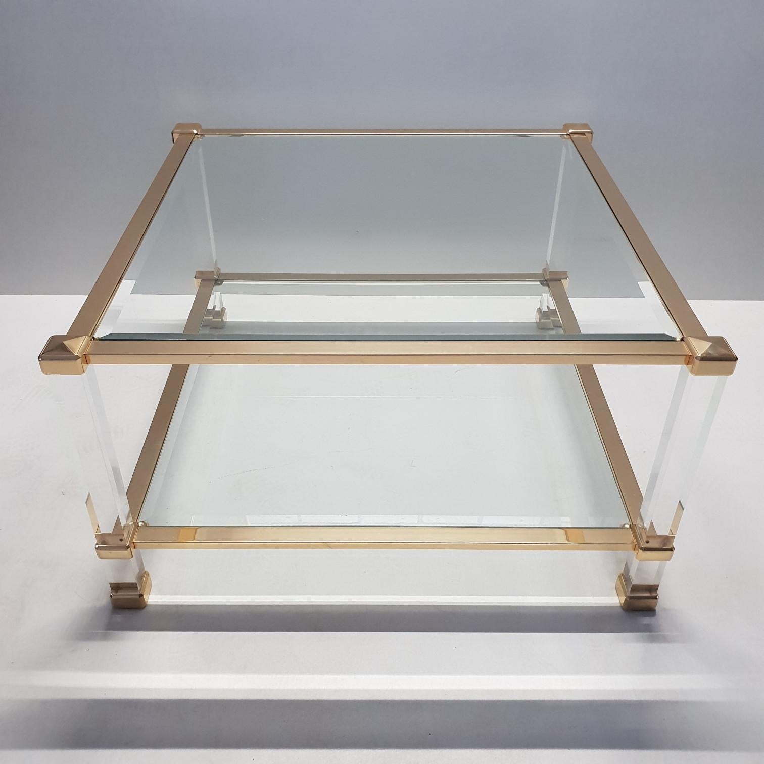 Italian Lucite and brass square coffee table by Orsenigo (marked), 1970s
Unique.

Orsenigo Furniture History - The company was founded in 1960 in Italy by the Orsenigo family, and continues to operate today north of Milan. The high end furniture