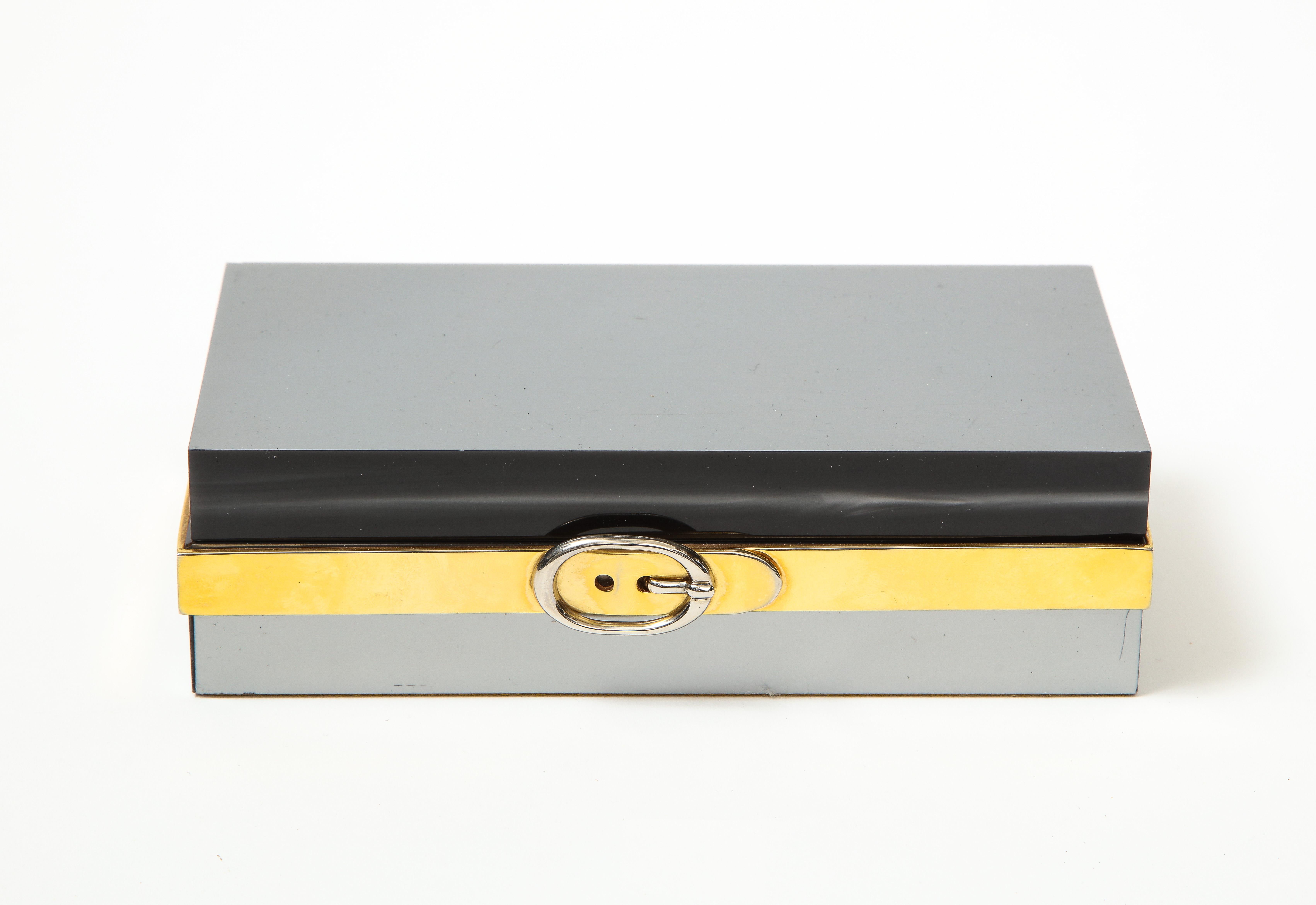 Italian Lucite and Chrome Box with Buckle Detail, c. 1970s

Chic 1970s Italian lucite and chrome decorative box. Sleek rectangular shape, three-toned composition, removable lid, felt-lined bottom, and unique buckle detail. 

This decorative box is