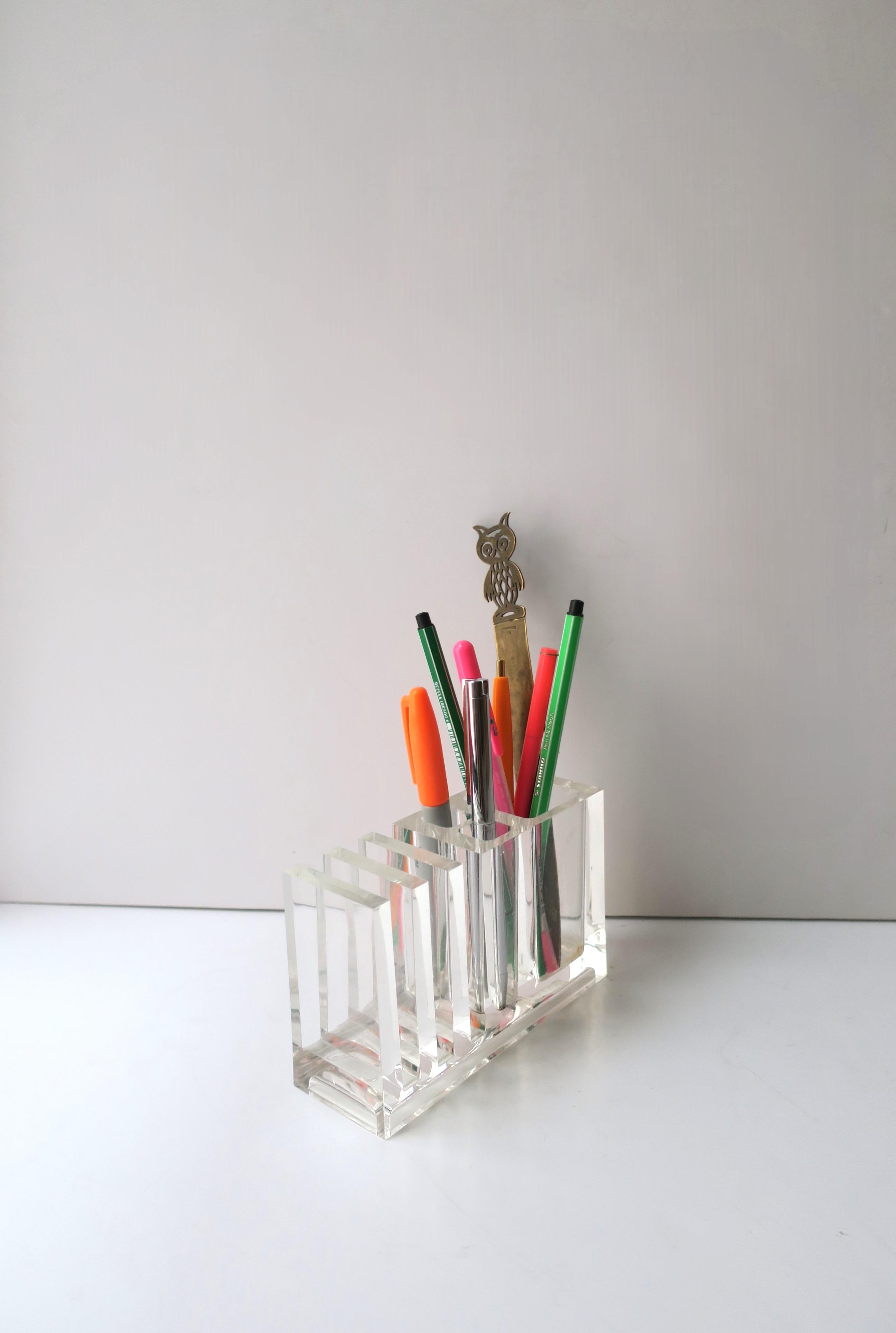 An Italian Lucite pen, pencil, marker and small paper desk organizer/holder, Postmodern period or Modern style, by designer Rede Guzzini, circa 1980s, Italy. A great desk accessory as demonstrated holding pens, markers, letter opener, and post card.