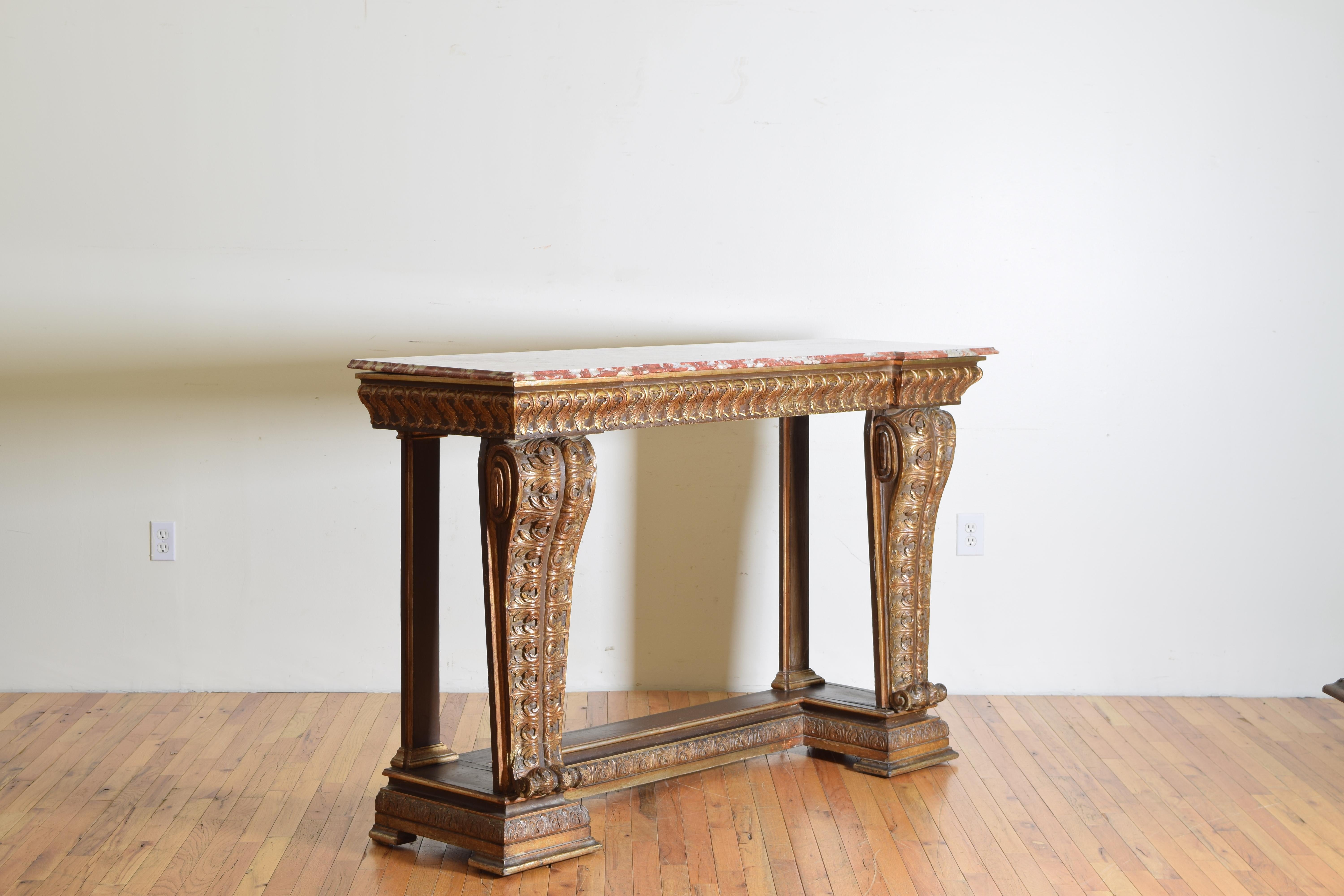 Having a shaped top with notched corners and a marble top, the front supports are large carved scrolls the bottom level mimicking the top in shape, second half of the 19th century.