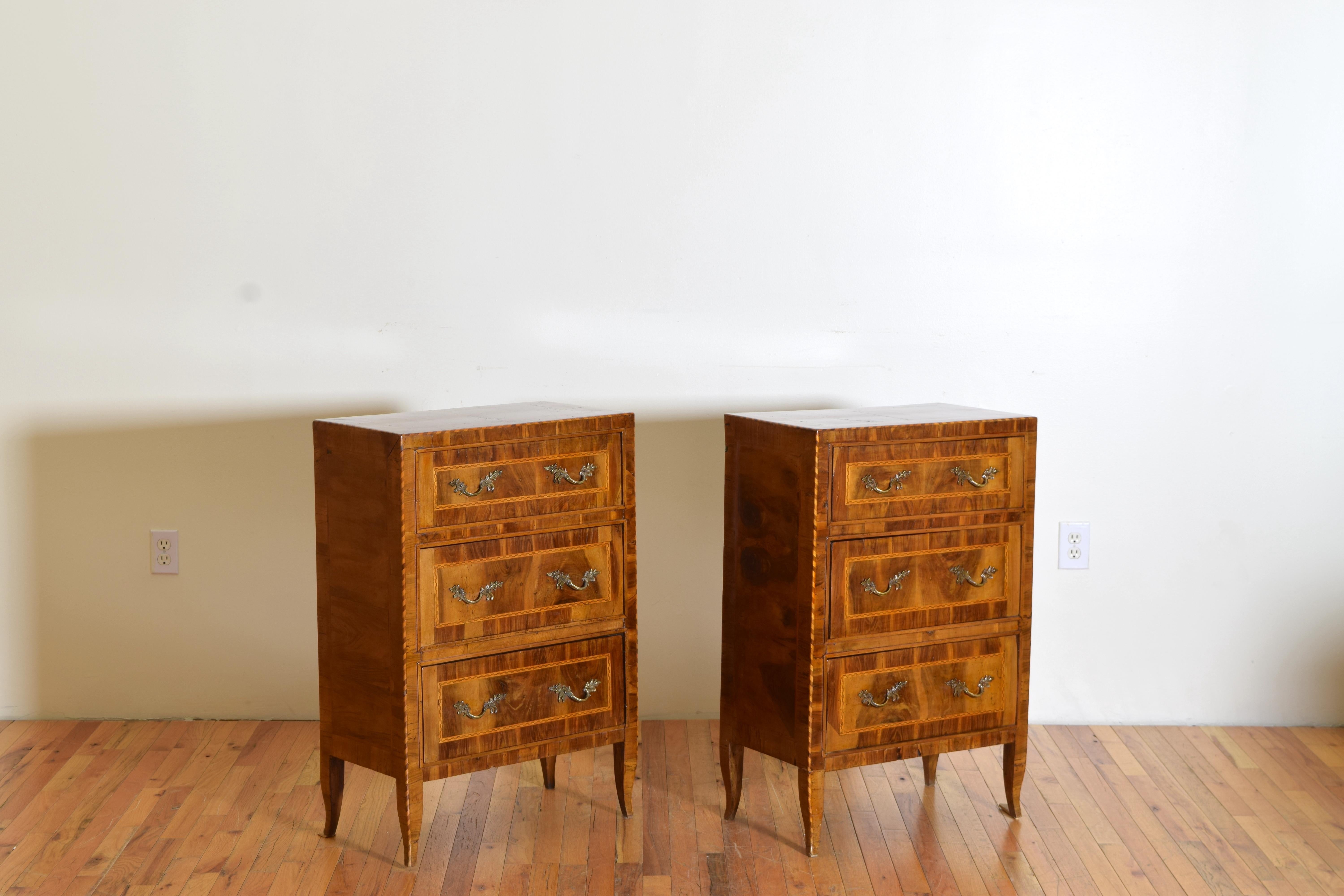A pair of finely Inlaid and veneered walnut three-drawer commodes with brass hardware from the Veneto Region, Italy.