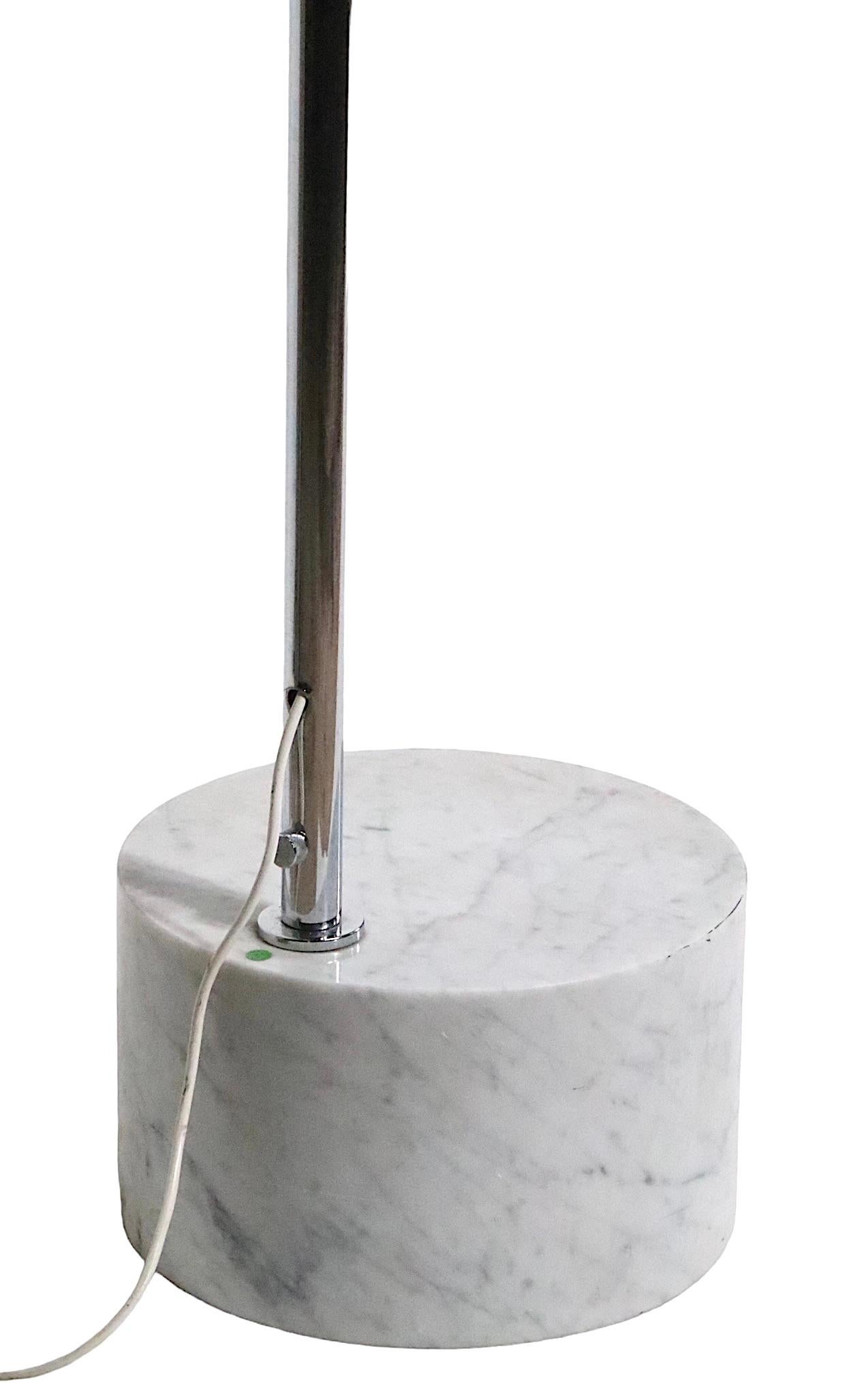 High quality Italian made arc floor lamp having a marble  cylinder form base of Caregga Marble, which supports an adjustable chrome arc form arm. The tubular chrome extends from the lowest height ( 77.5 inches  ) to the height ( 97 inches ). 
 The