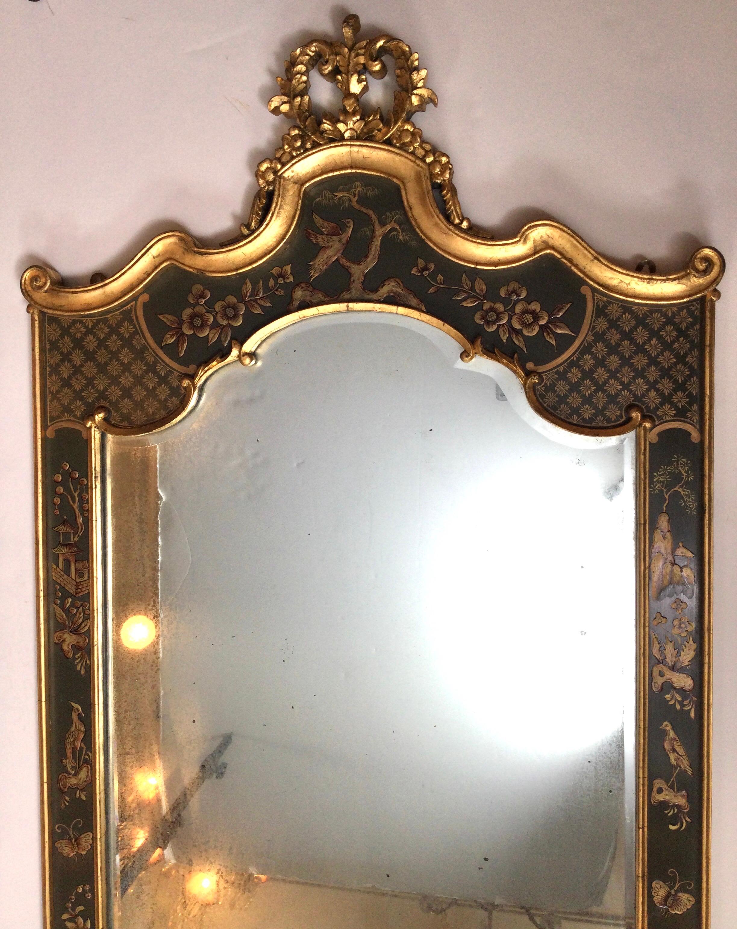 Elegant hand painted chinoiserie beveled glass wall mirror. Made in Italy, mid-later 20th century. The frame is in excellent condition with the mirror with an intentional aged finish to the silvering, measures 44.5 high, 24.25 wide.