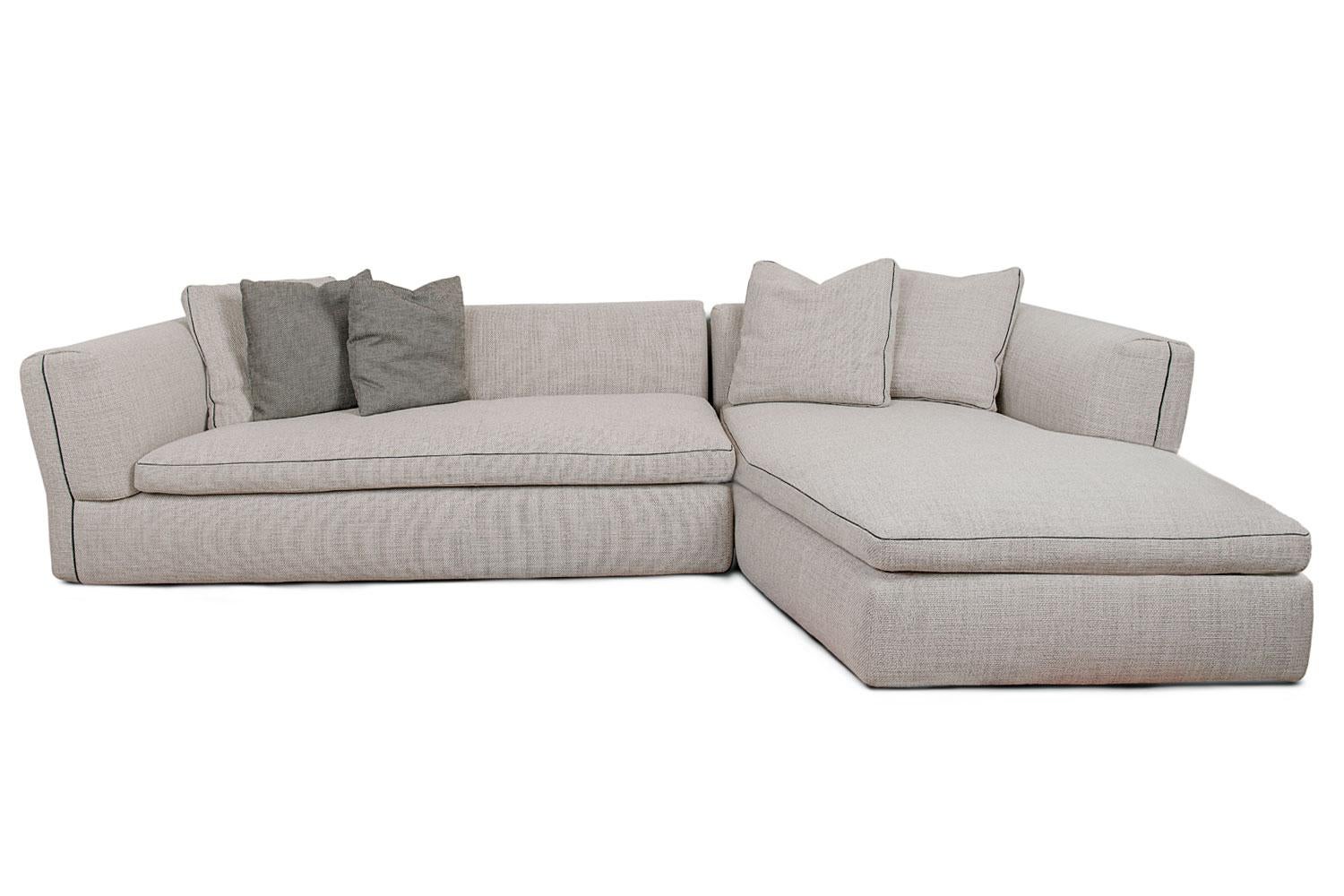 Dress Up sofa sectional by Cassina is characterized by elegant details that recall dressmaking craftsmanship from the fashion world. The black grosgrain piping is edged and contrasts beautifully with the Pearl colored woven nubby fabric cover.