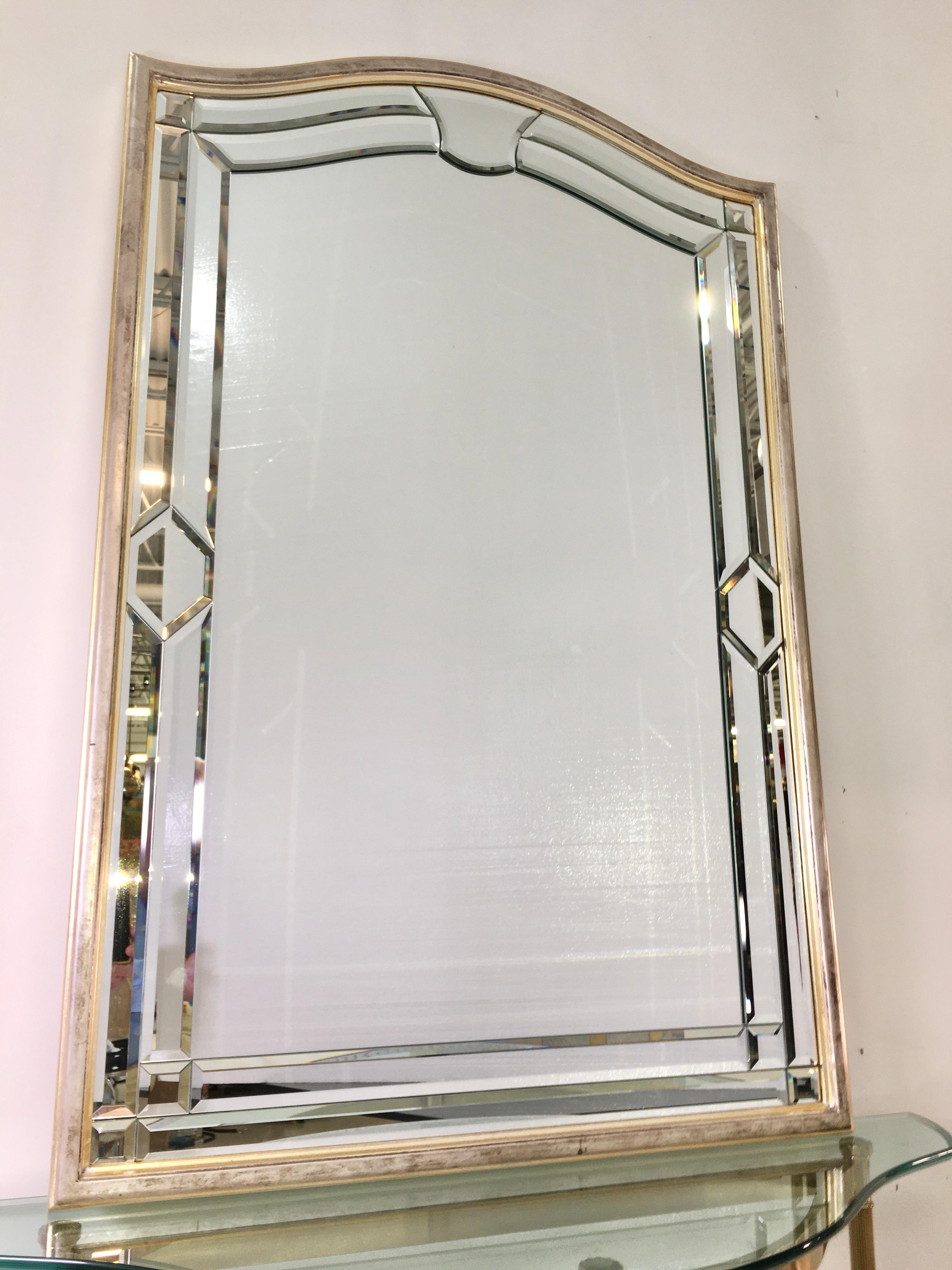 Vintage wall mirror made of 24 pieces of individual beveled glass in wood frame with silver leaf and mecca finish. Label on verso reads decorative crafts, Inc. Handcrafted imports. Made in Italy. 10386/641.
Decorative Crafts of Greenwich, CT has