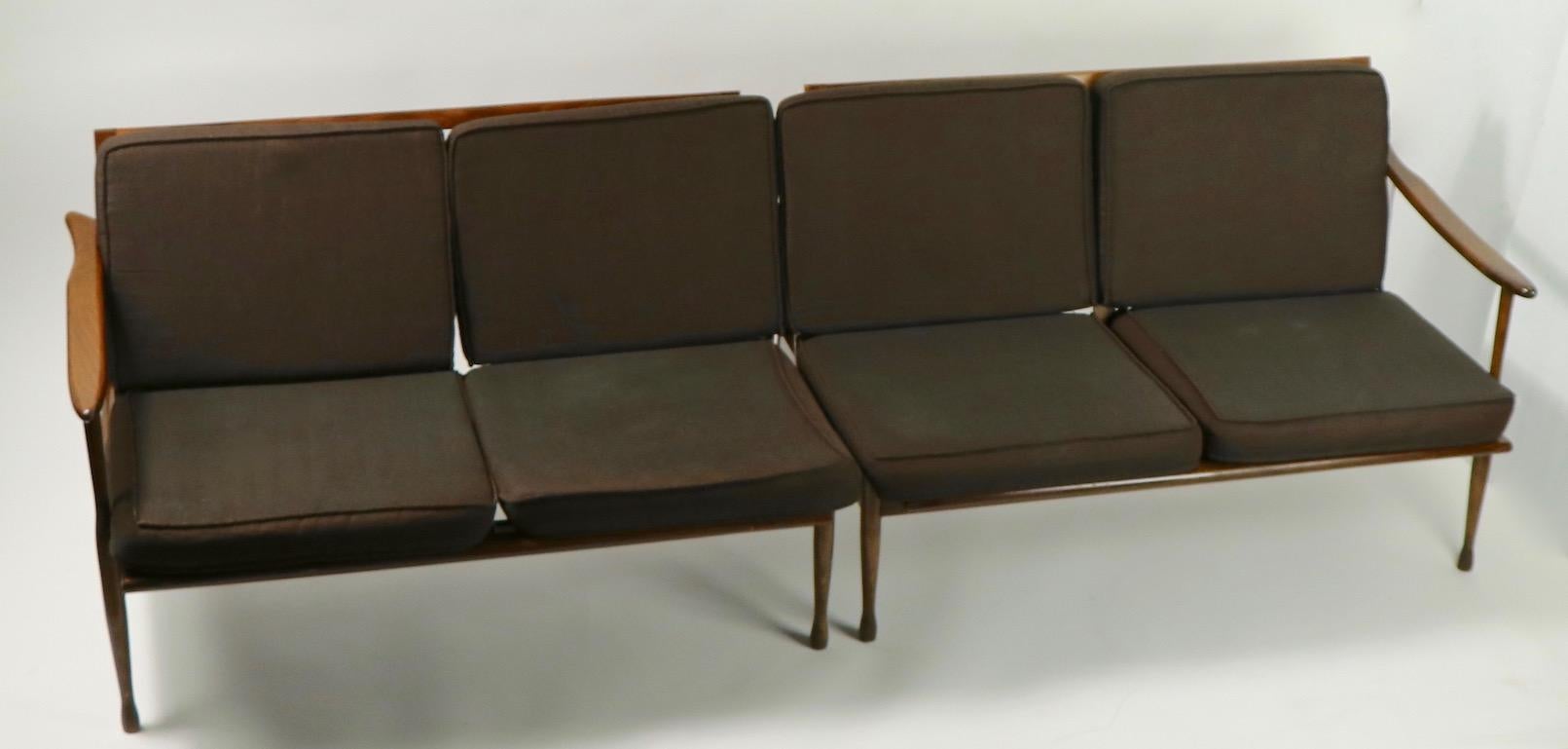 Interesting sectional sofa marked made in Italy that exhibits obvious reference to Danish modern design. Open arm frames support loose cushion upholstery, original fabric which shows normal cosmetic wear consistent with age. This is a sectional