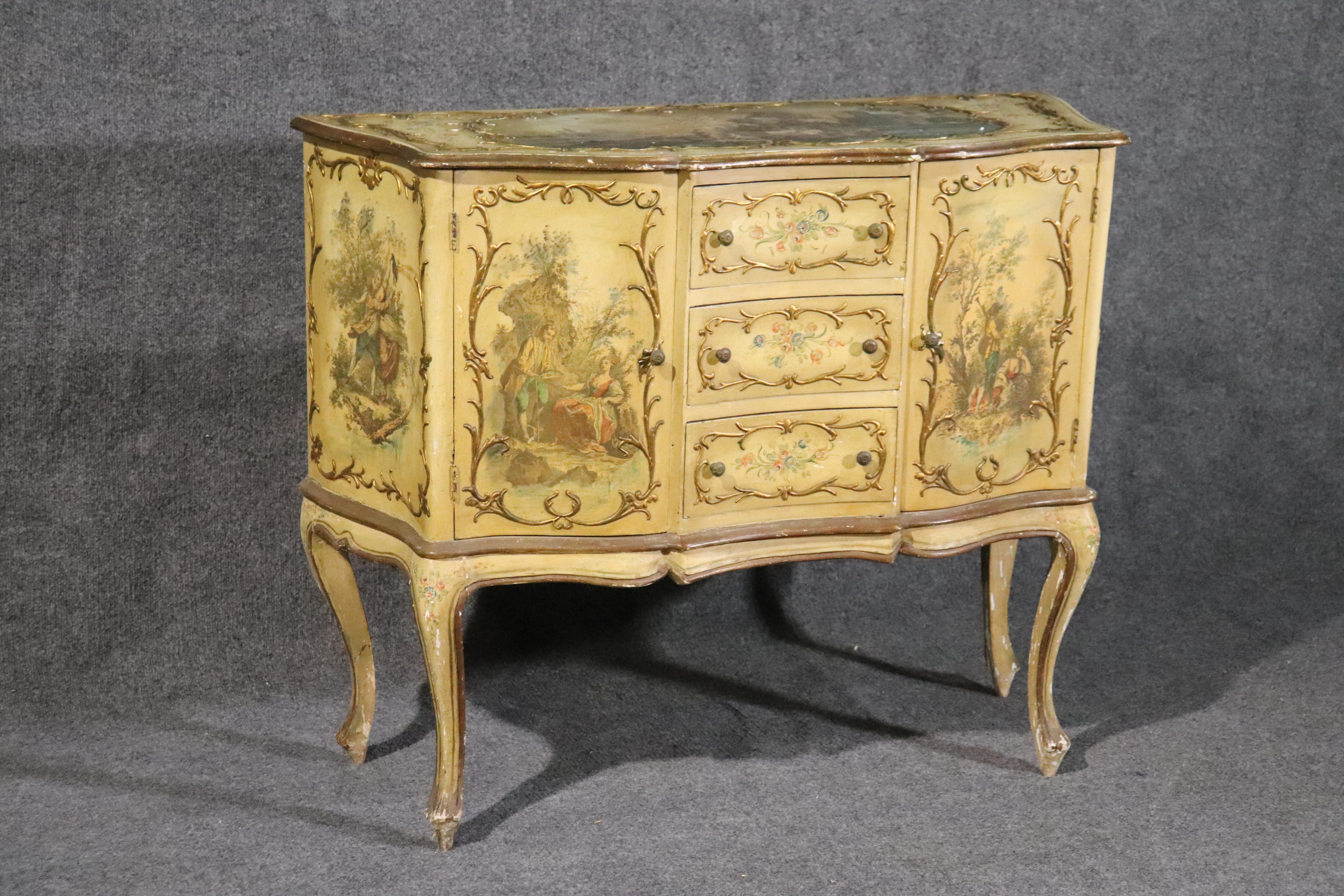 This is a beautifully made, time-worn Italian take on a French design. The piece has a great original finish and exhibits 100 years of use but does it nicely. The cabinet can be used as a buffet or sideboard and measures 40 wide x 33.5 tall x 16