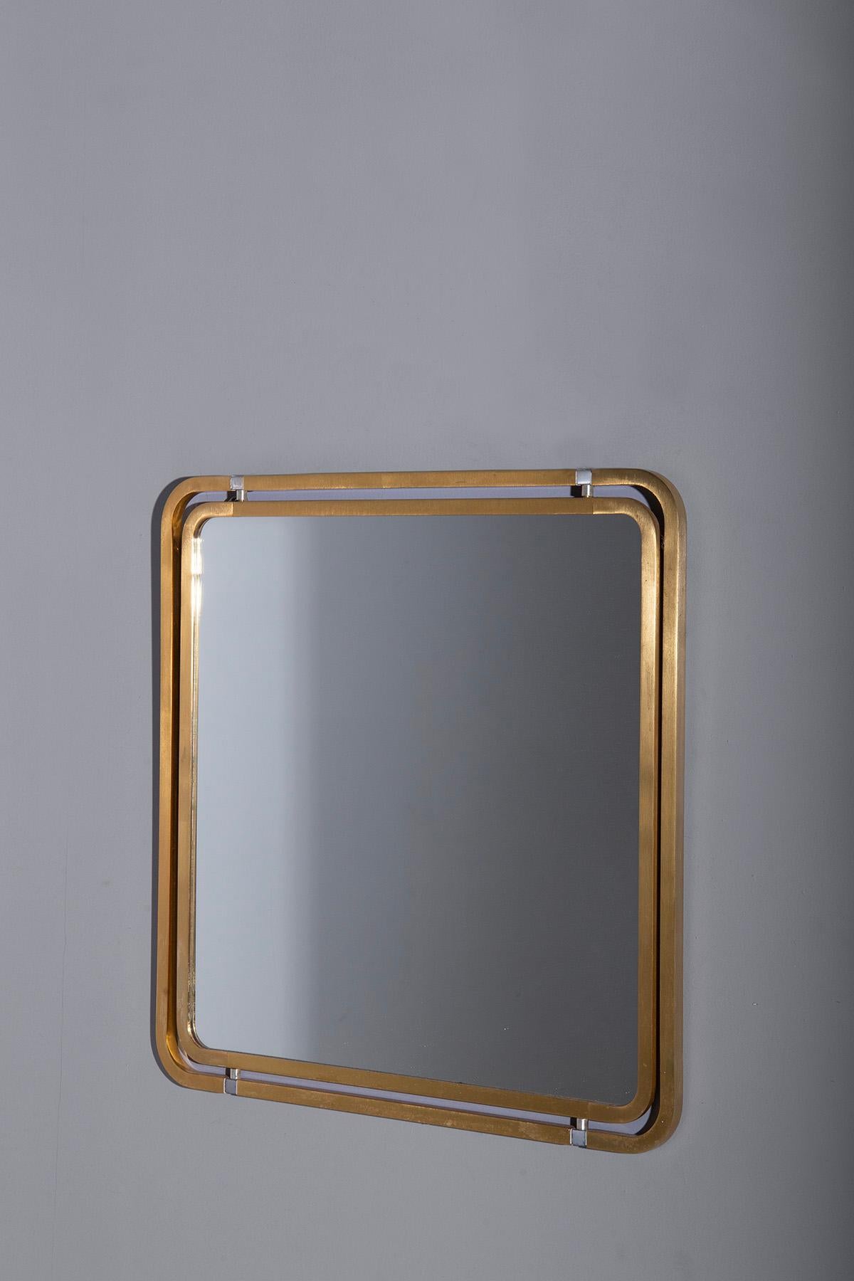 Step into the glamorous world of 1960s Italian design with this exquisite vintage gilt metal mirror. A true embodiment of the era's modern and essential aesthetic, it stands as a radiant testament to the artistry of its time.

The mirror's design is