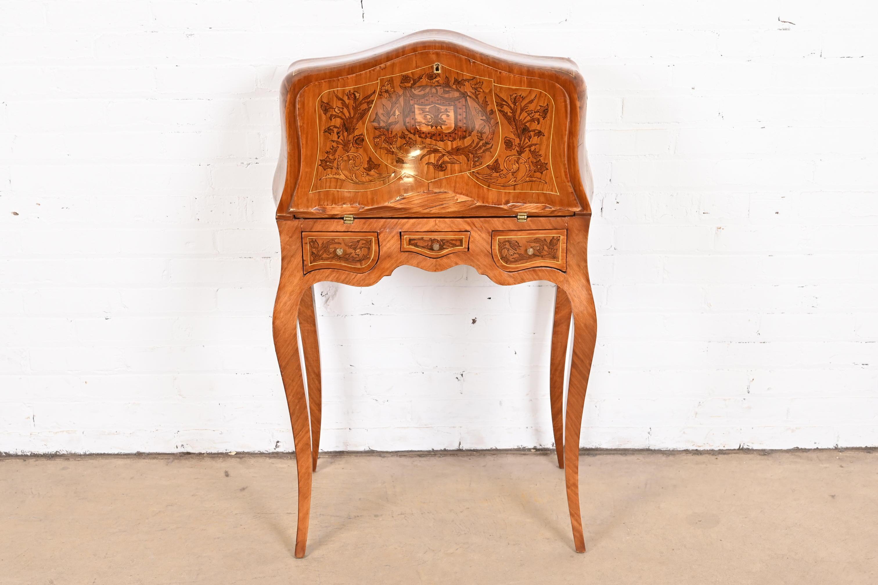 A gorgeous Italian petite slant front writing desk or secretary desk

Italy, circa Mid-20th century

Mahogany and burl wood, with beautiful marquetry inlay, and original brass hardware.

Desk measures: 23.75
