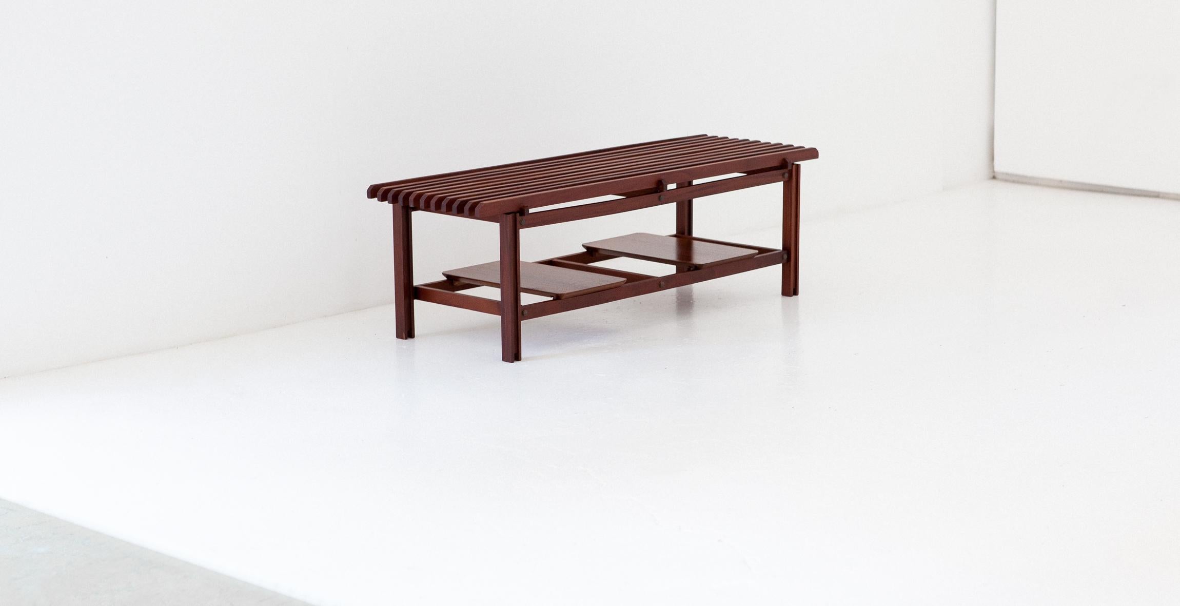 Mid-Century Modern bench, manufactured in Italy in 1950s
Made of solid mahogany wood with two extractable teak trays that can be used such as a magazine and book holder. Brass bolts.
Completely restored, sanded and oil finished. 
The designer is