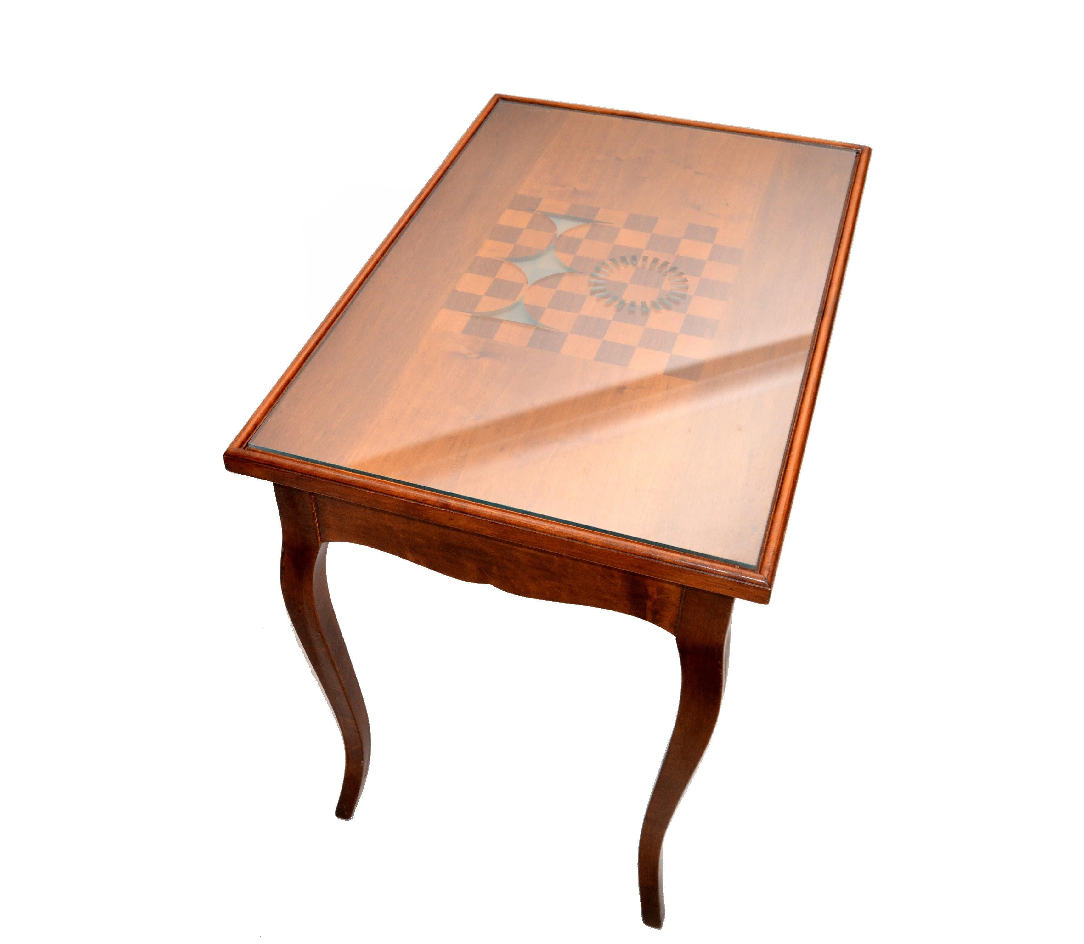 Mid-Century Modern reversible mahogany table into a chess or backgammon game table.
The top can be rotated into a chess game or taken off to play backgammon.
Legs and apron are hand-carved. Contains 2 pullout drawers for accessories. 
The