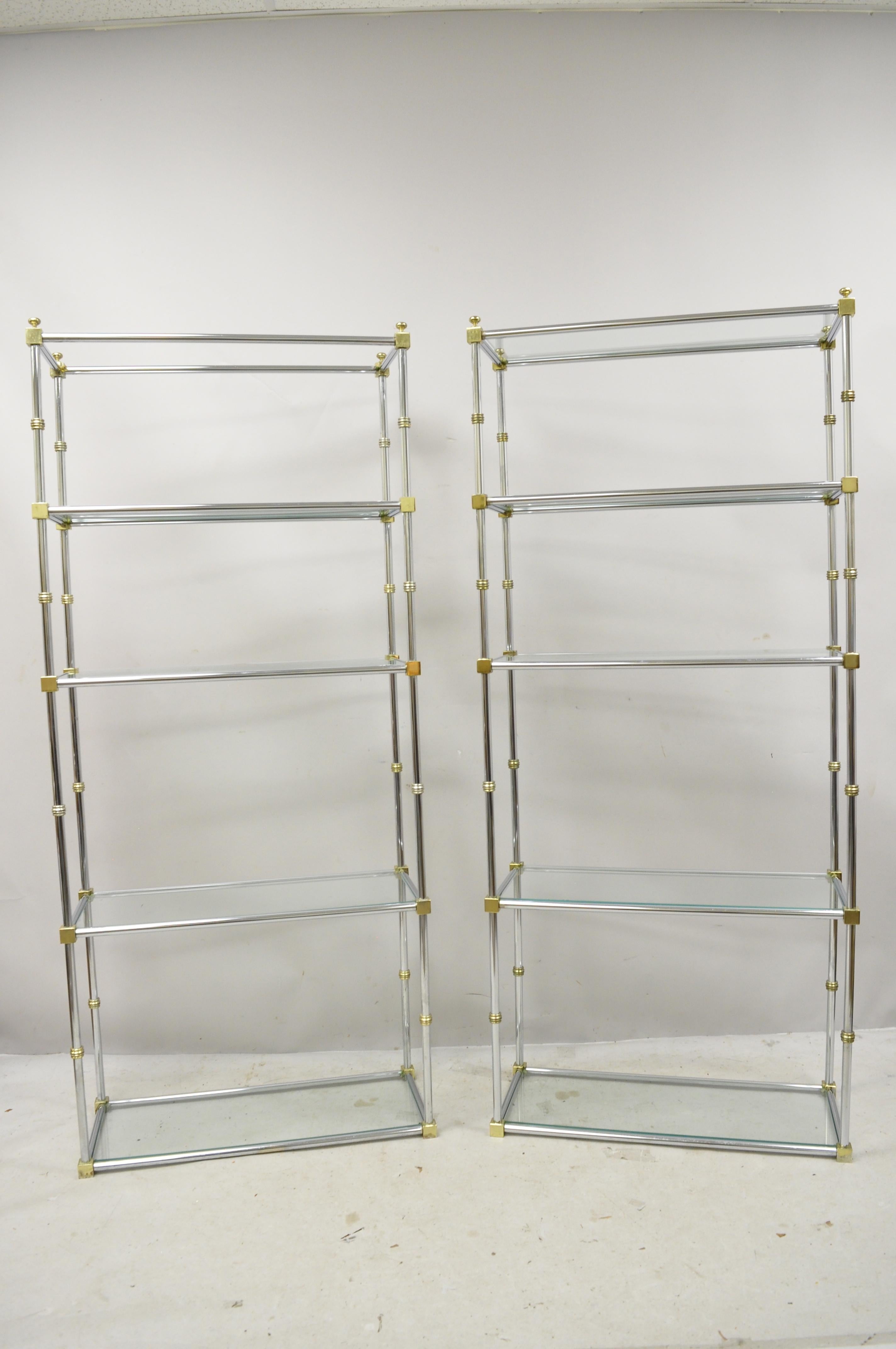 Italian Maison Jansen style faux bamboo chrome brass and glass étagères - a pair. Item features chrome frames, brass accents, glass shelves, quality Italian craftsmanship, great style and form, circa 1970. Measurements: 71